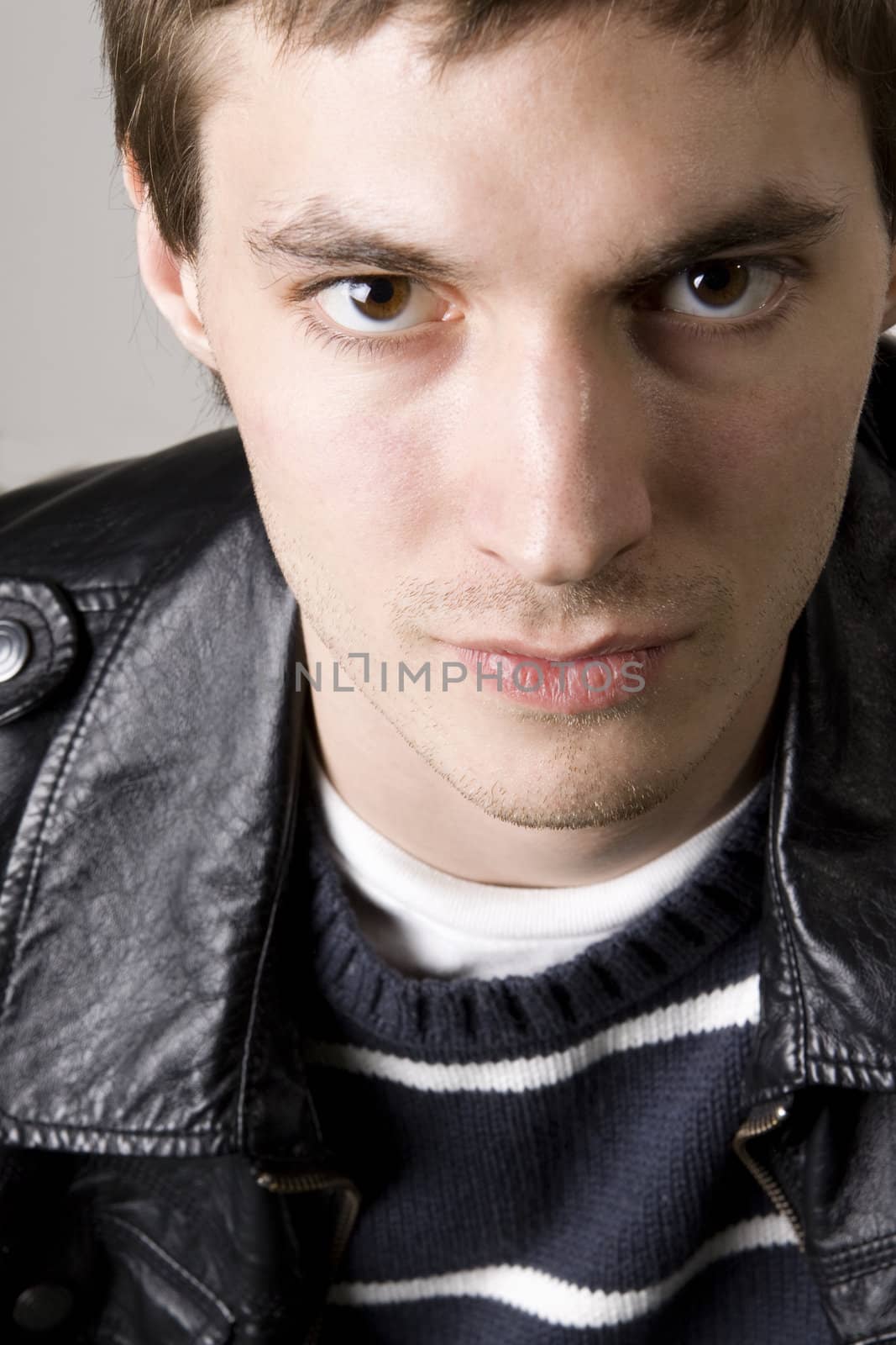 Portrait of a handsome young man wearing leather jacket