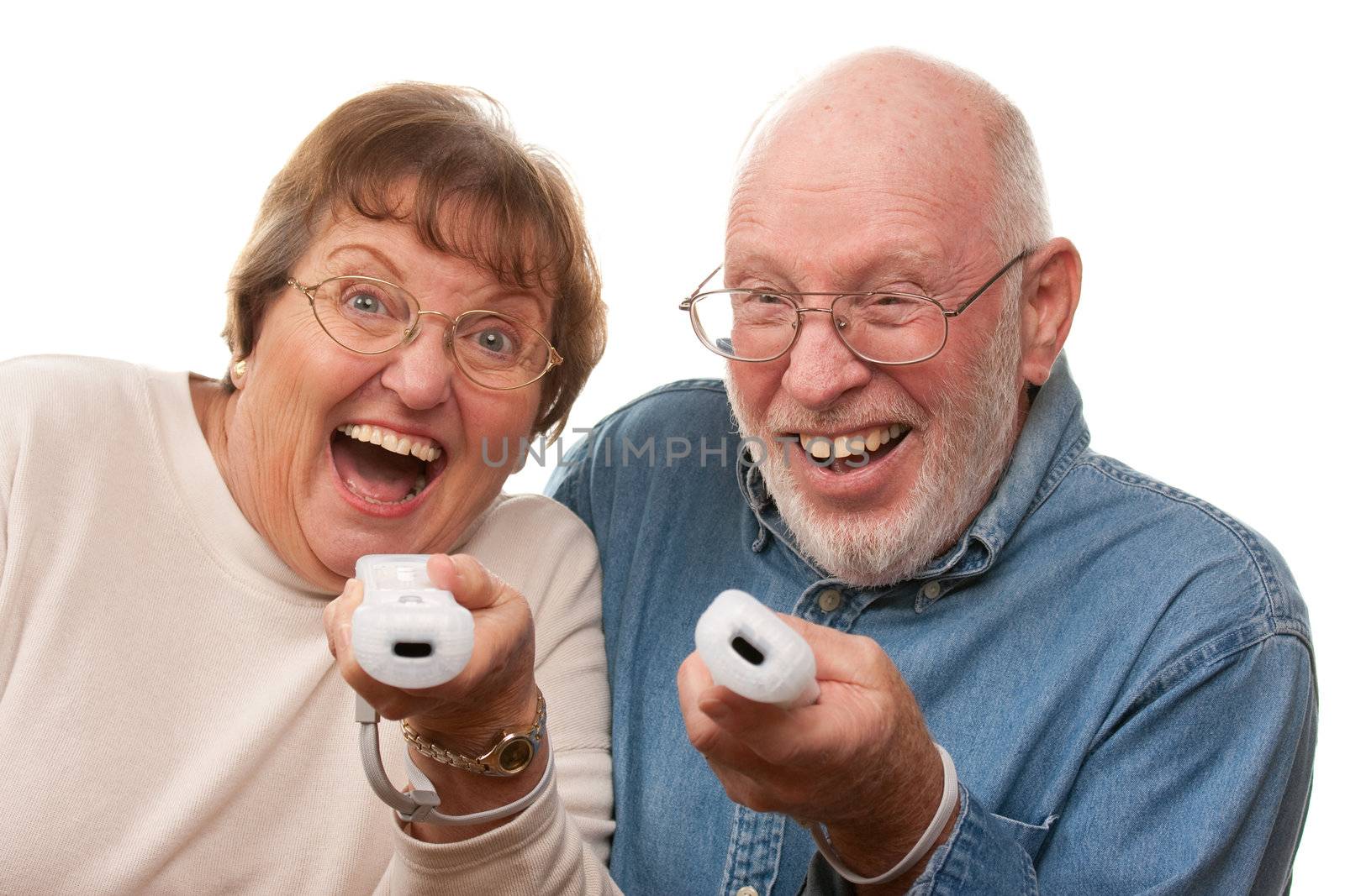 Happy Senior Couple Play Video Game with Remote Controls.
