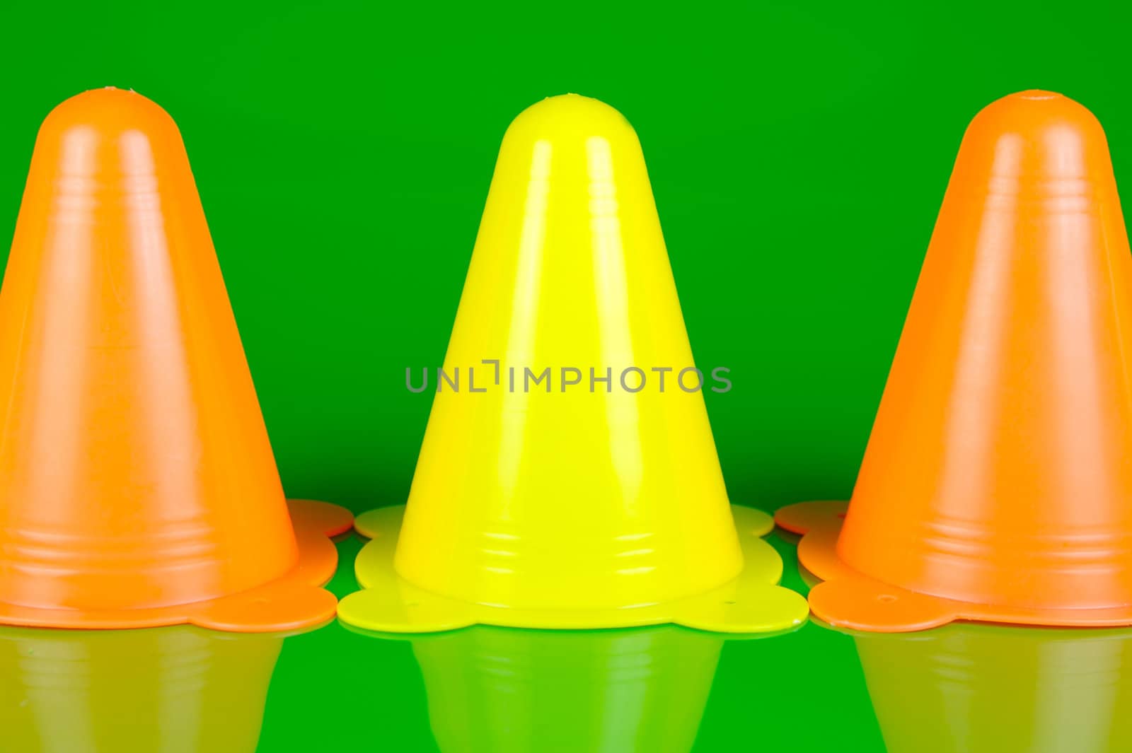 Witches hats isolated against a green background