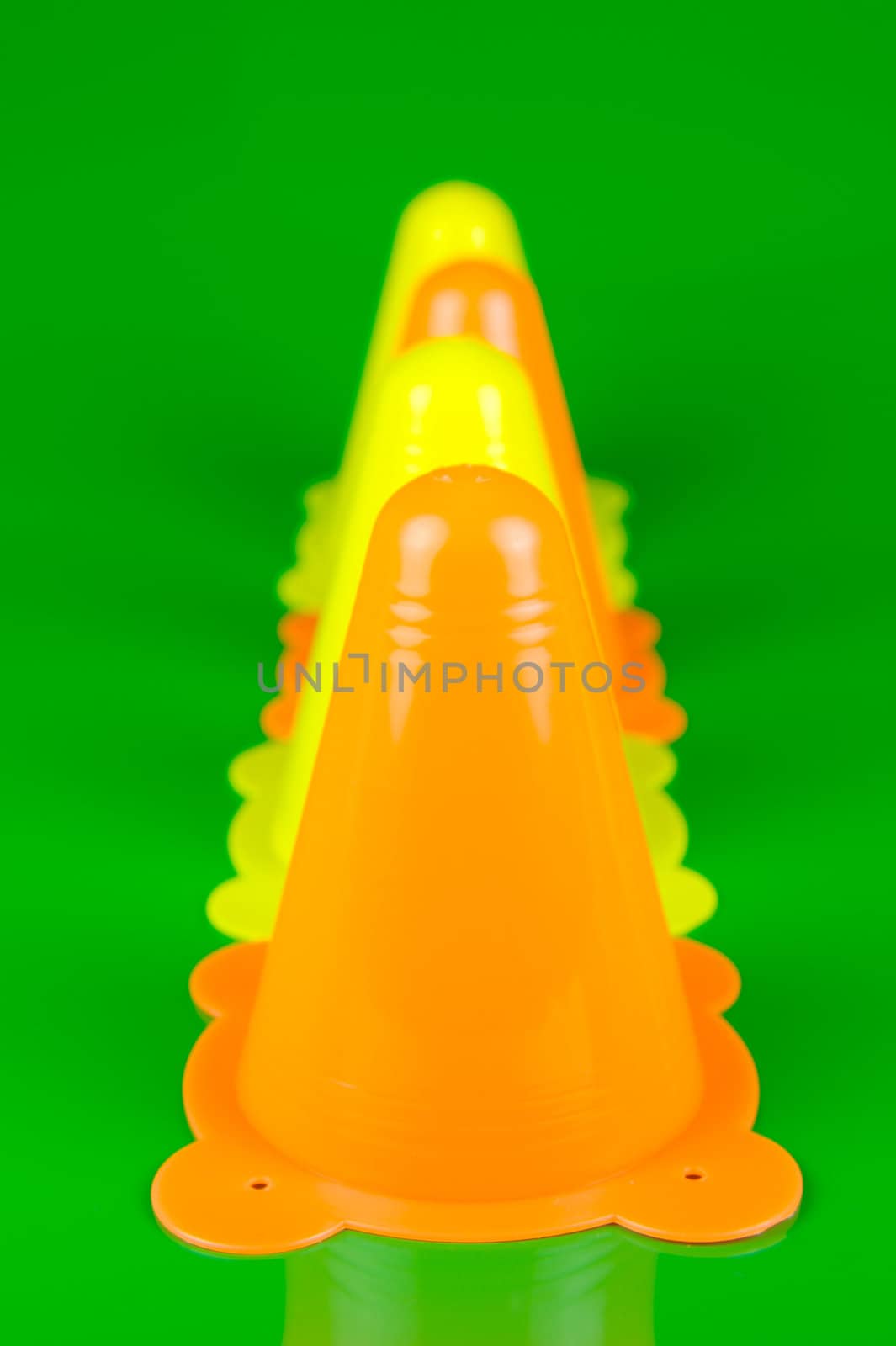 Witches hats isolated against a green background