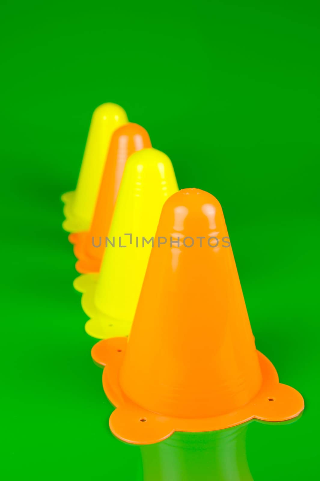 Witches hats isolated against a green background