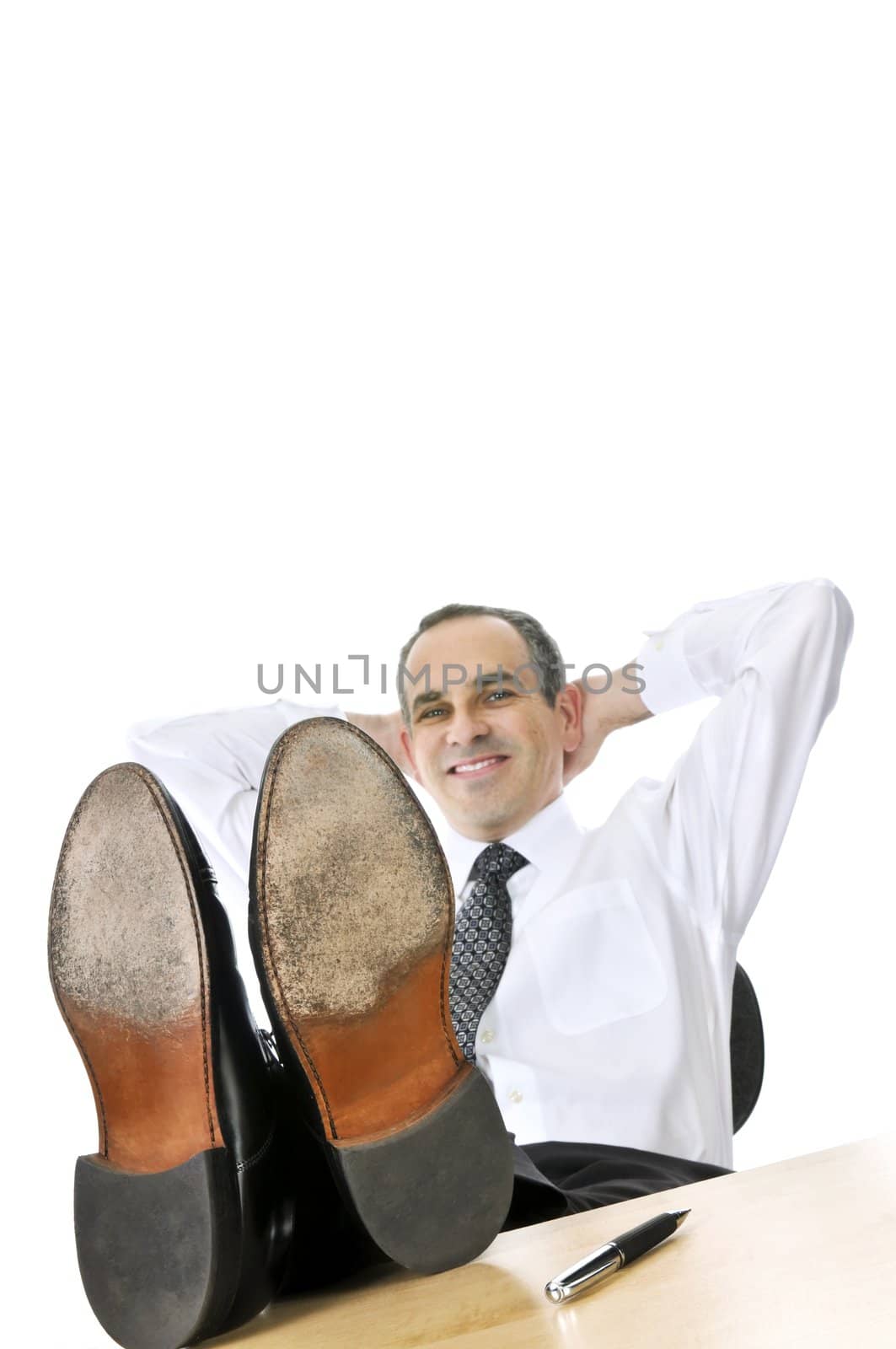 Relaxing businessman with feet up on his desk