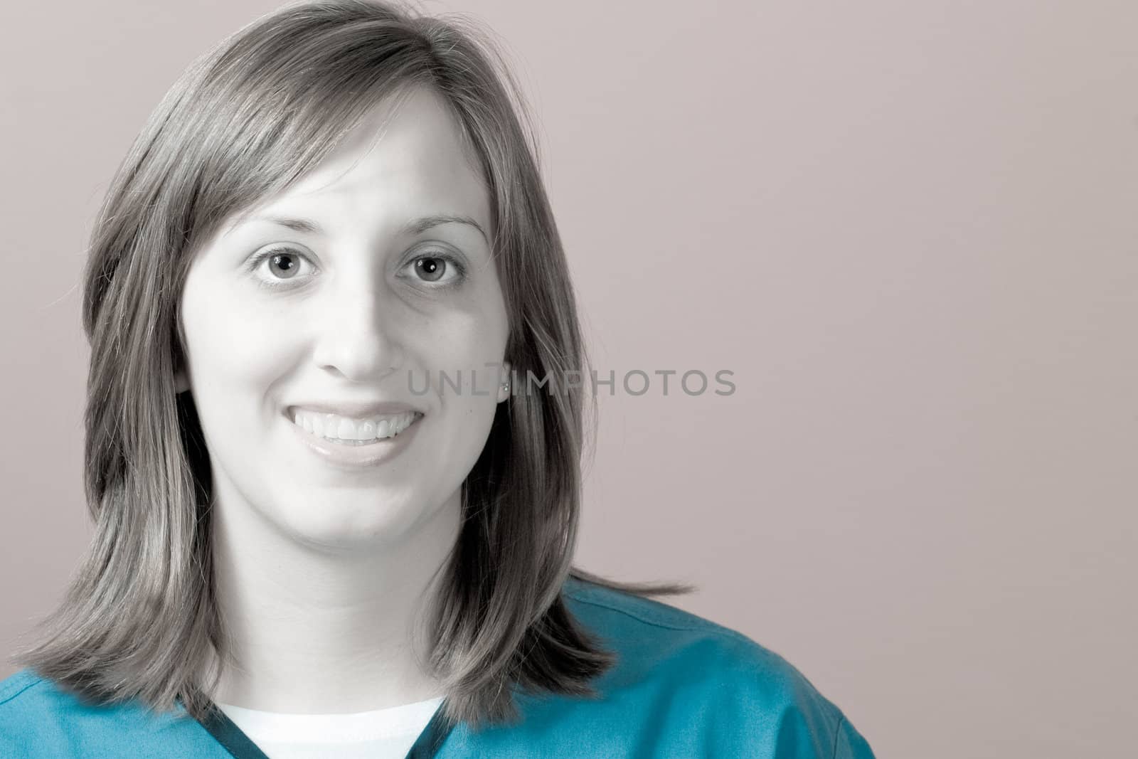 A closeup of a nurse smiling with selective color.