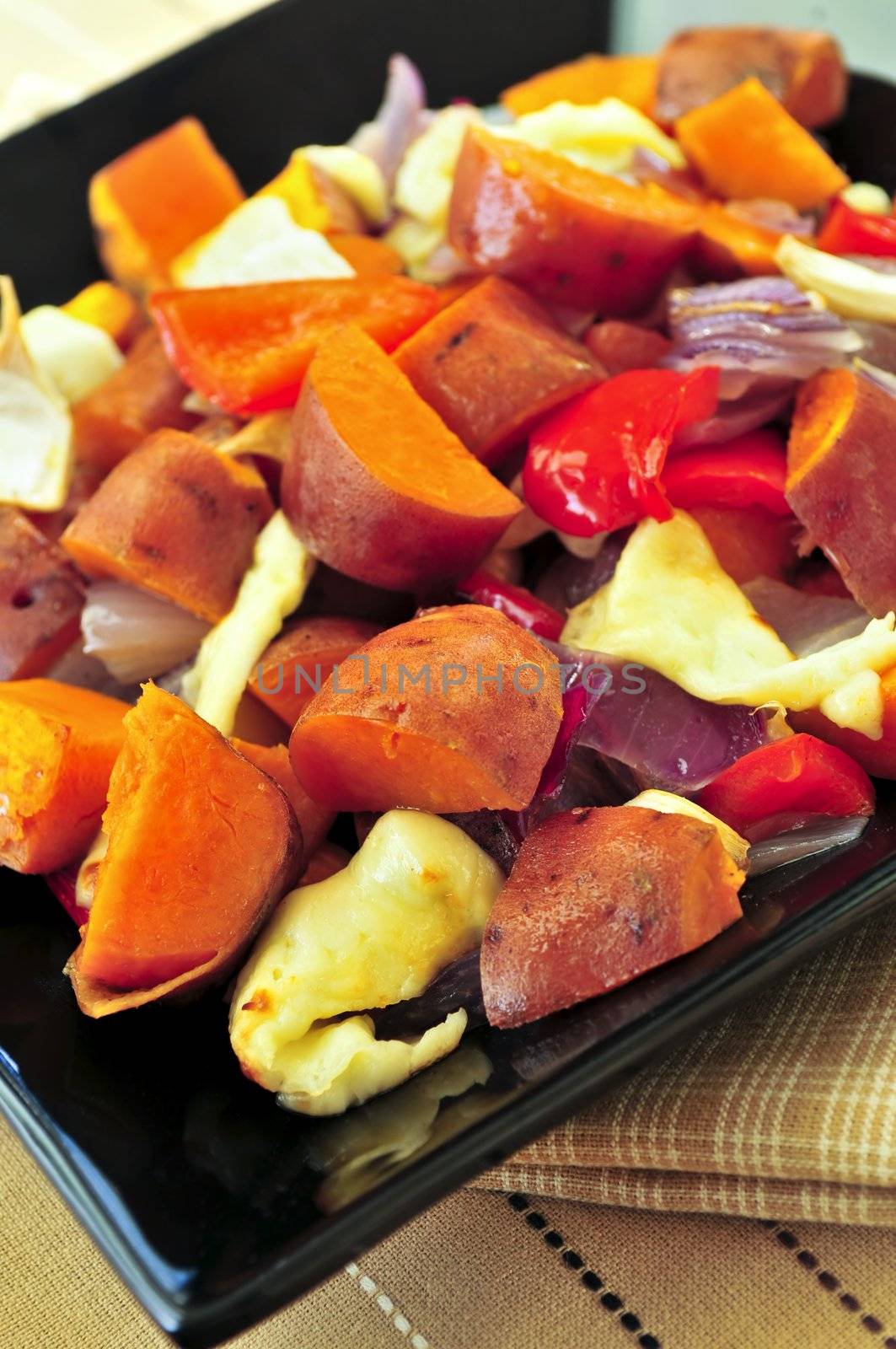 Vegetarian dish of roasted yams with cheese and peppers