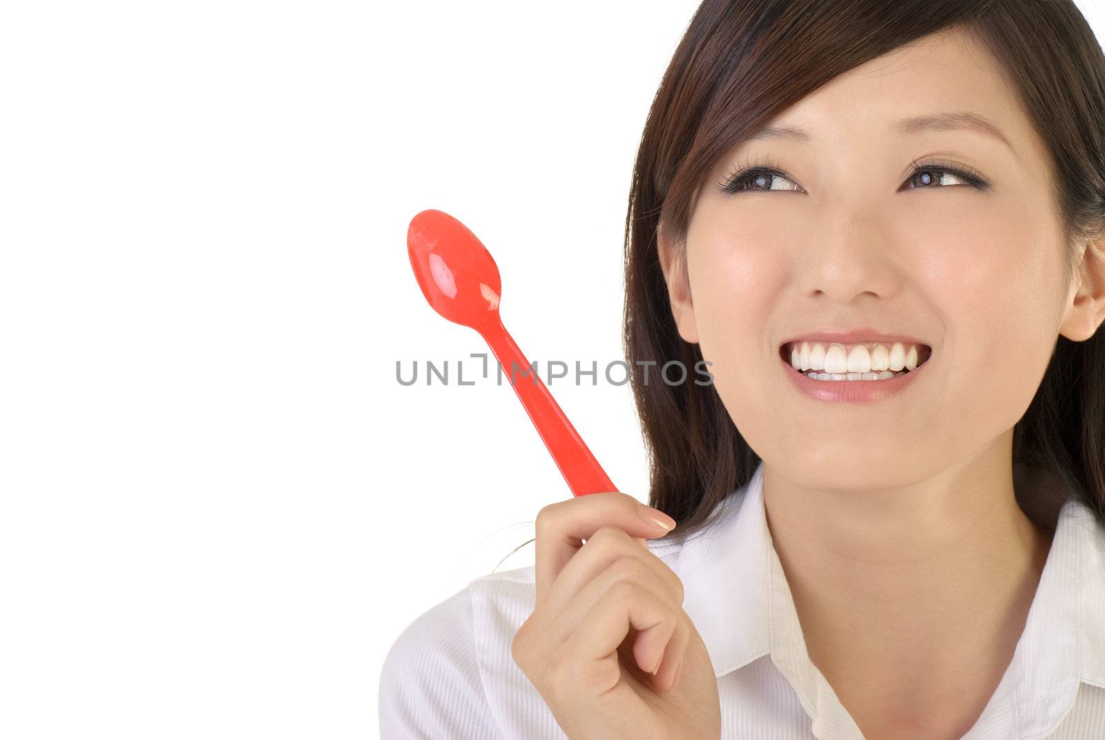 Happy business woman holding tablespoon, closeup portrait of oriental office lady on white background.