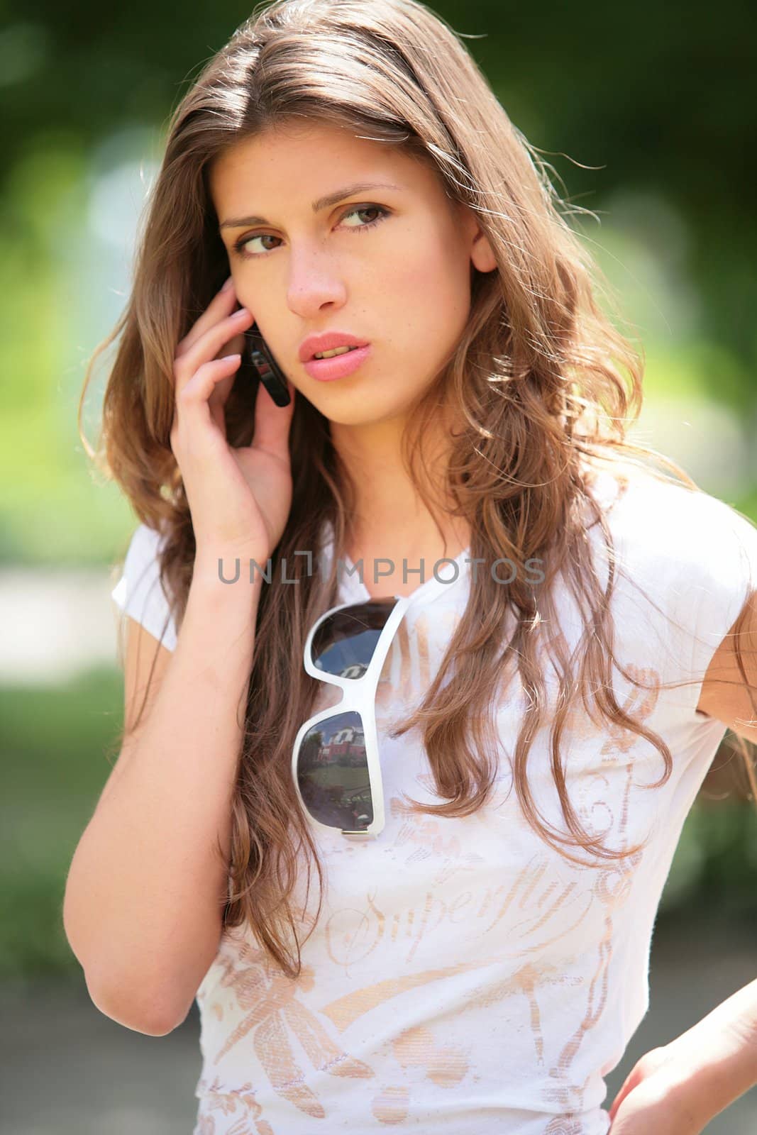 long-haired girl speaks on mobile phone