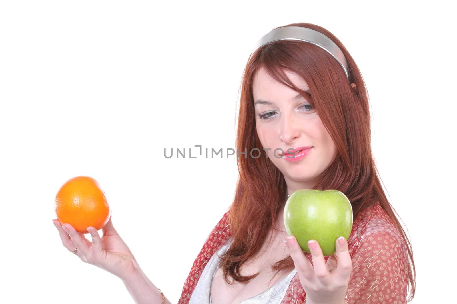 girl makes a choice between orange and apple with copy-space