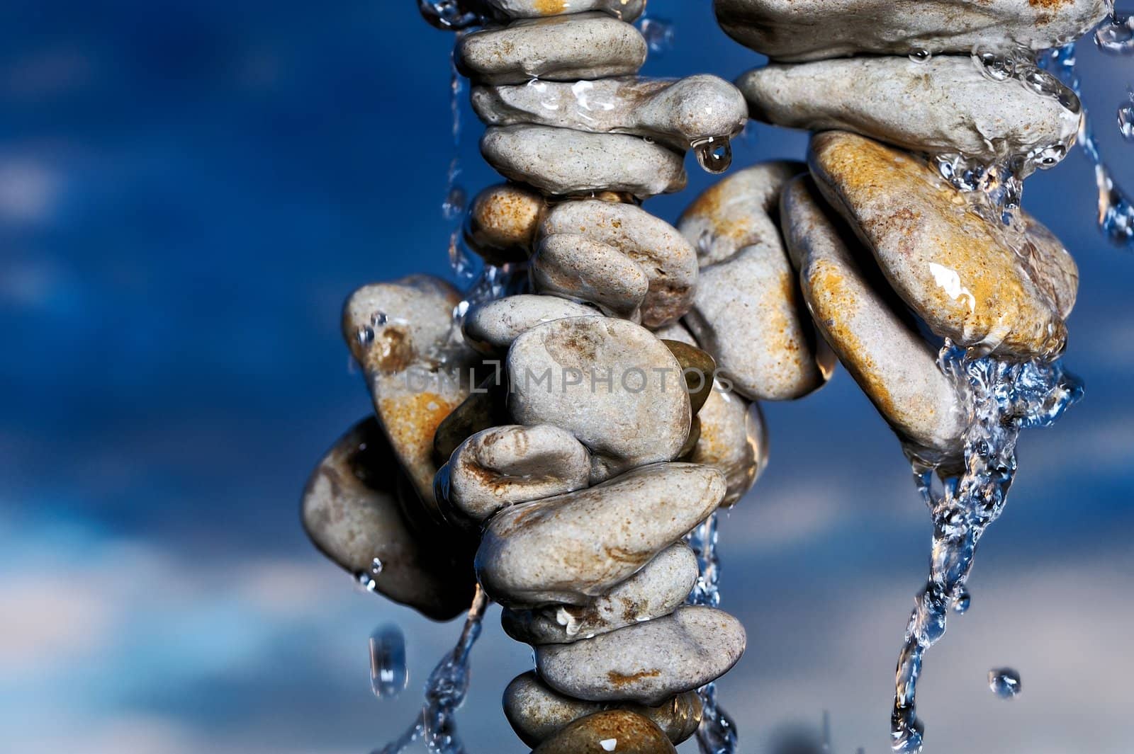 Water on a pile of sea stones in the evening