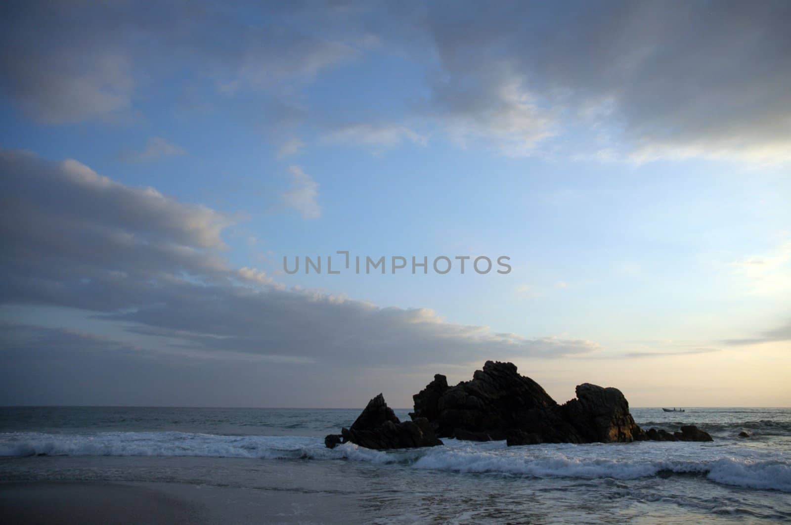 Silhouette of monument during sunset over the beach of Puerto Escondido