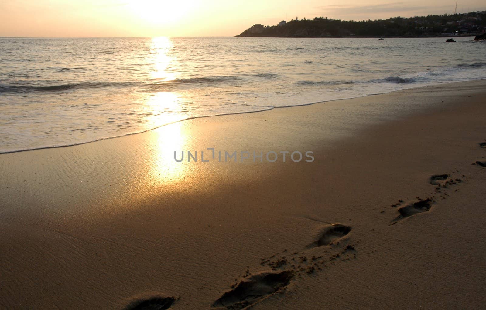 Footprints in sand on the beach during the sunset, Puerto Escondido, Mexico