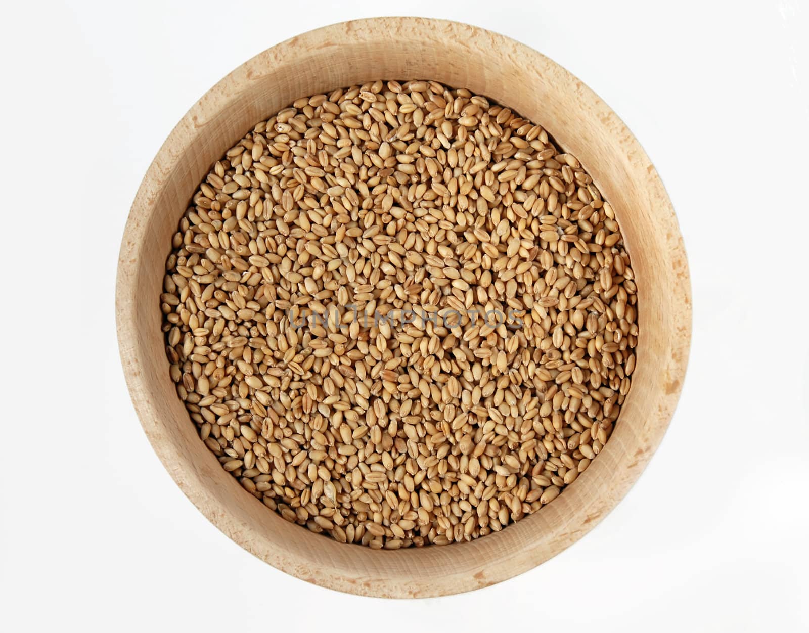 wheat in wooden bowl isolated over white