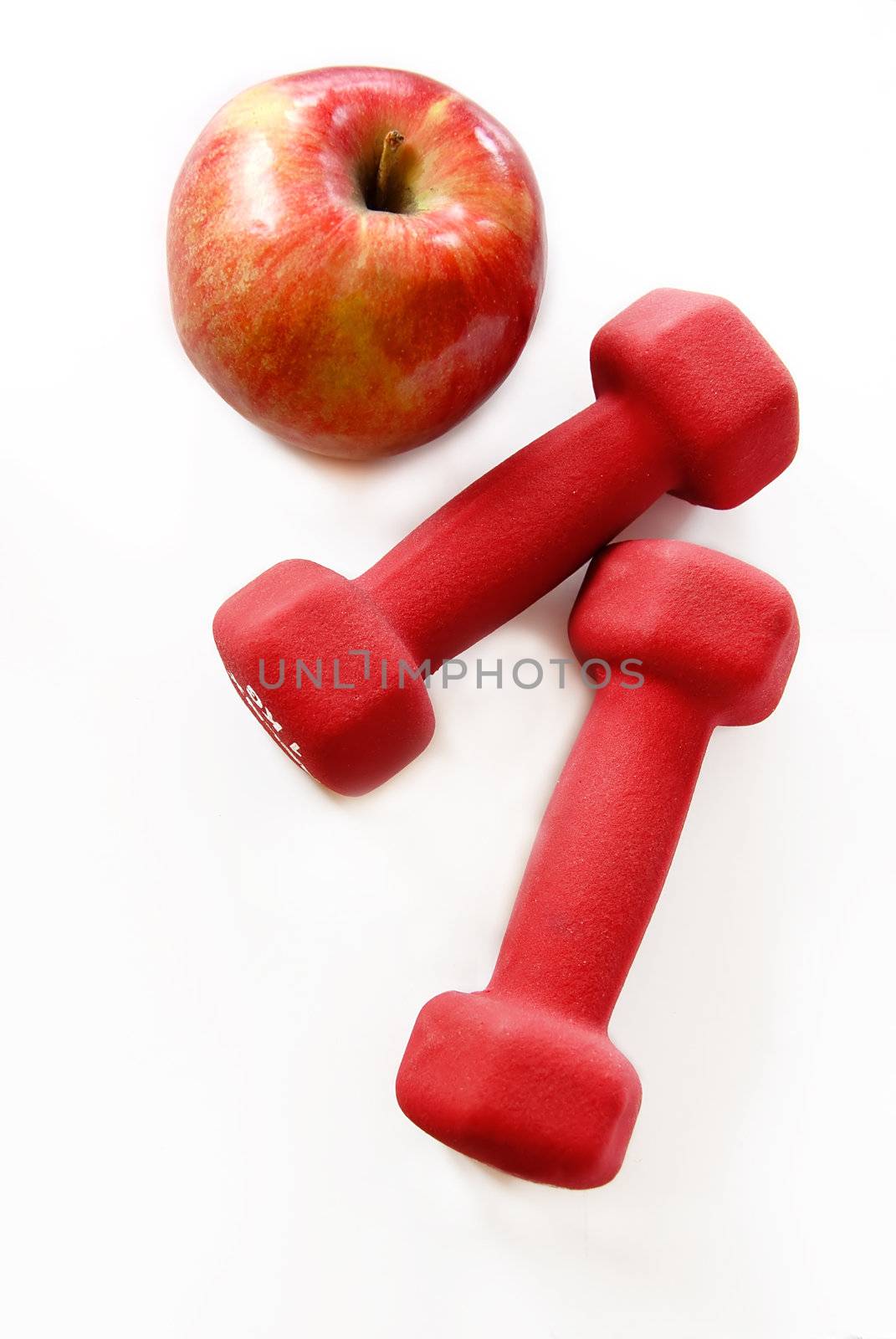 two red dumbbells and red apple isolated on white