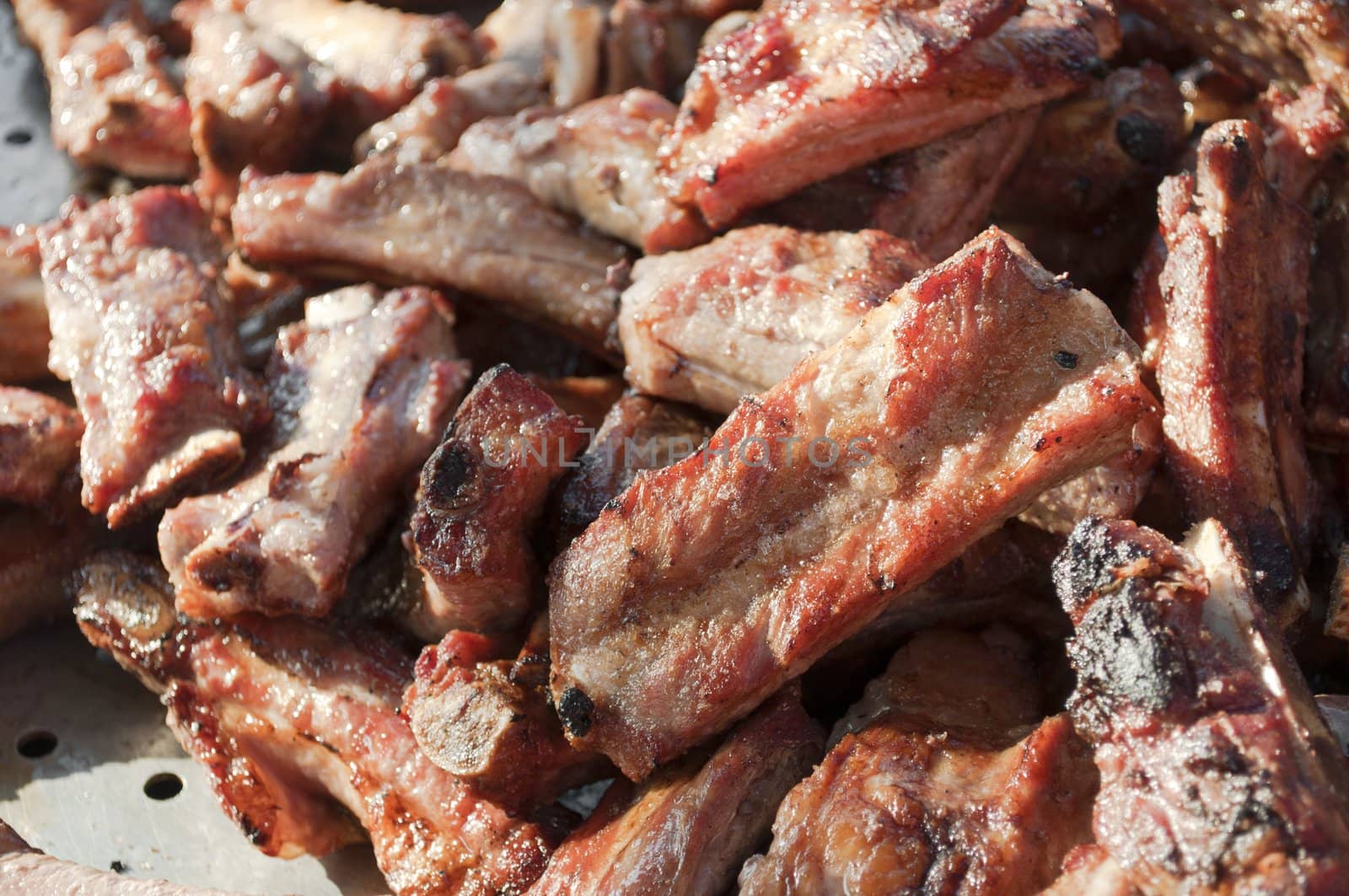Grilled pork meat cooked on a barbecue close-up