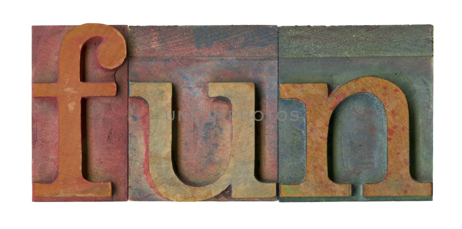 fun word in vintage wooden letterpress type blocks, stained by color ink, isolated on white