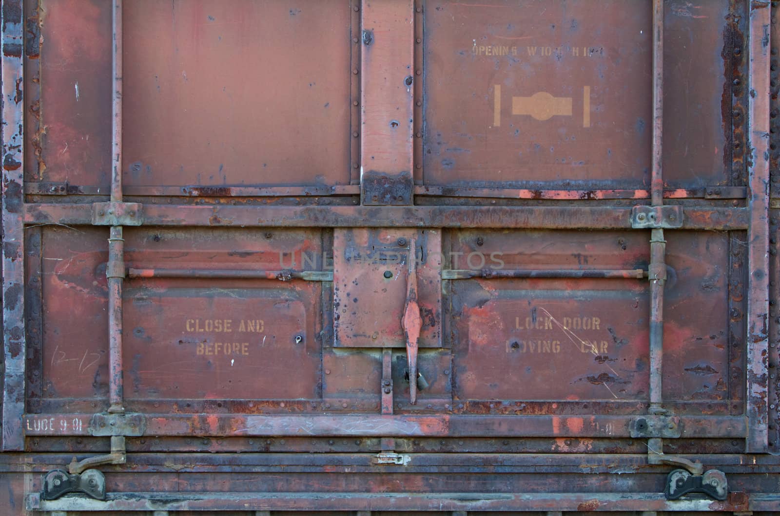 Red rusted old railroad car door and latch