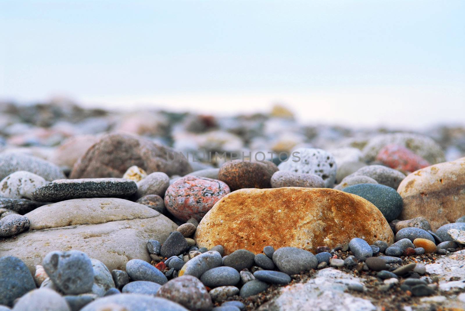 Background of colofrul beach pebbles of different shapes and water