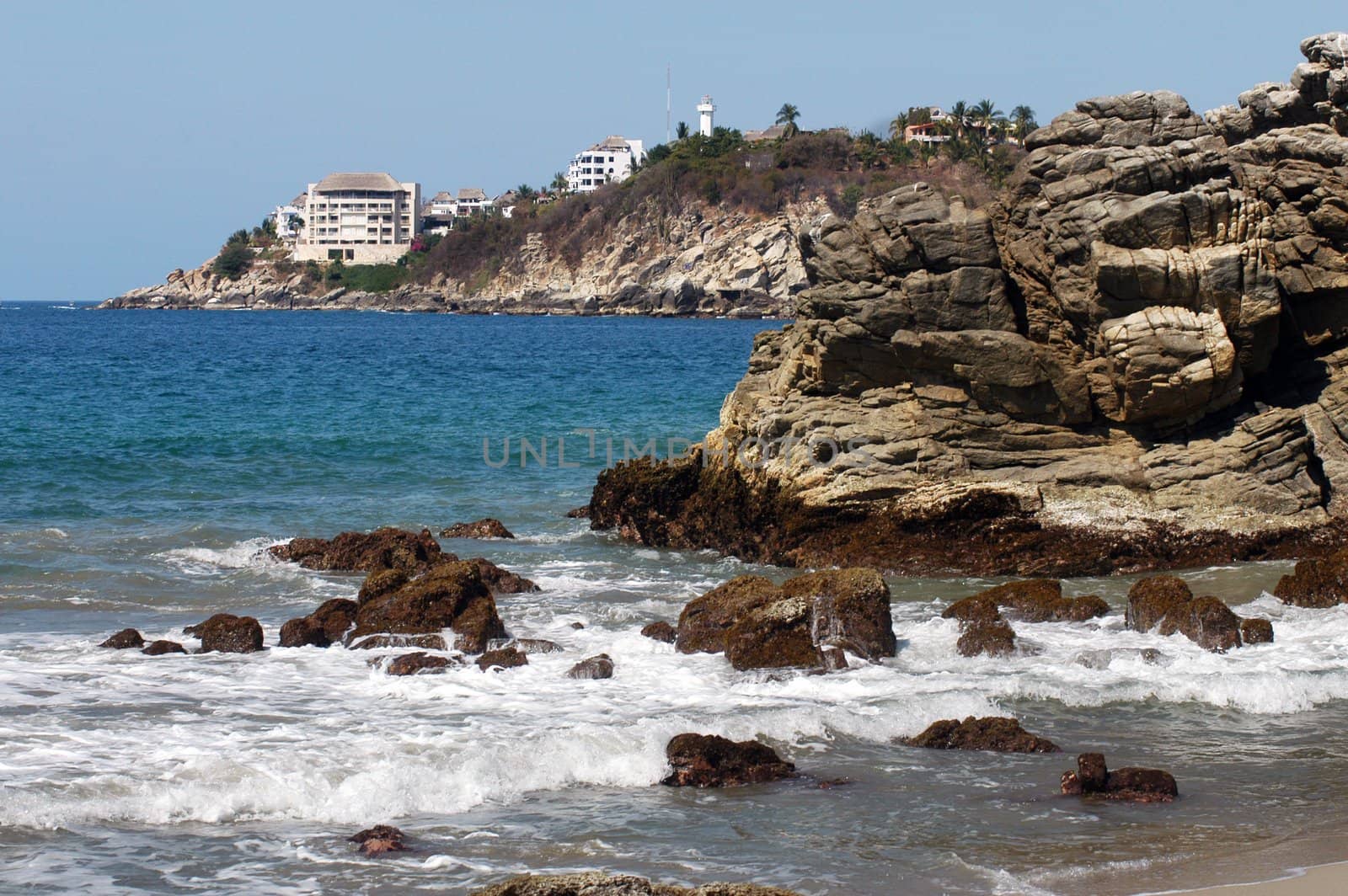 Bay in Puerto Escondido with hotel and lighthouse, Mexico