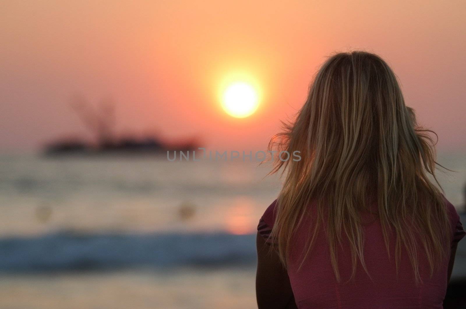 Blond woman watching sunset in Puerto Escondido, Mexico by haak78