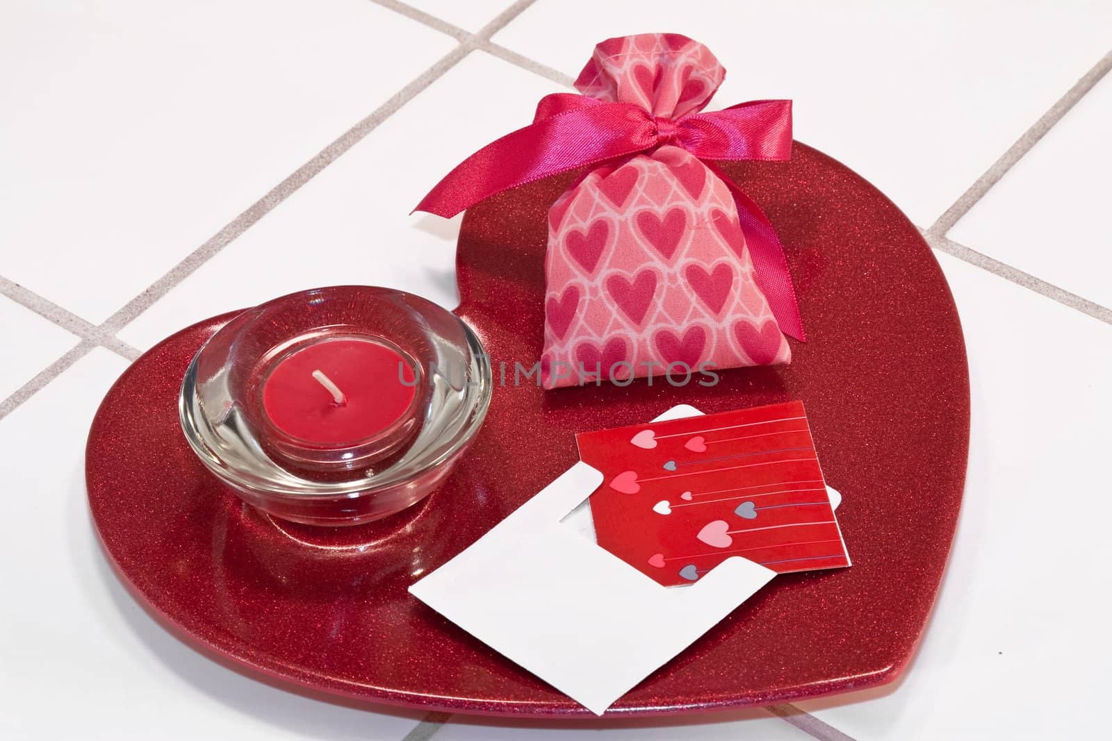 Red metallic heart dish with red candle in holder and valentine sachet with card