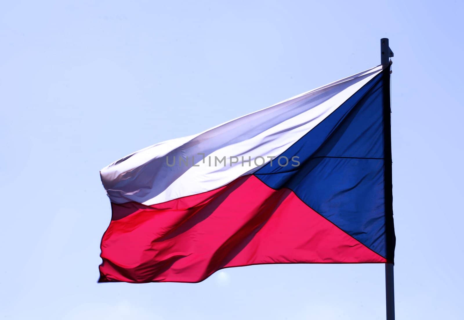 Flag of Czech republic blowing on blue sky by haak78