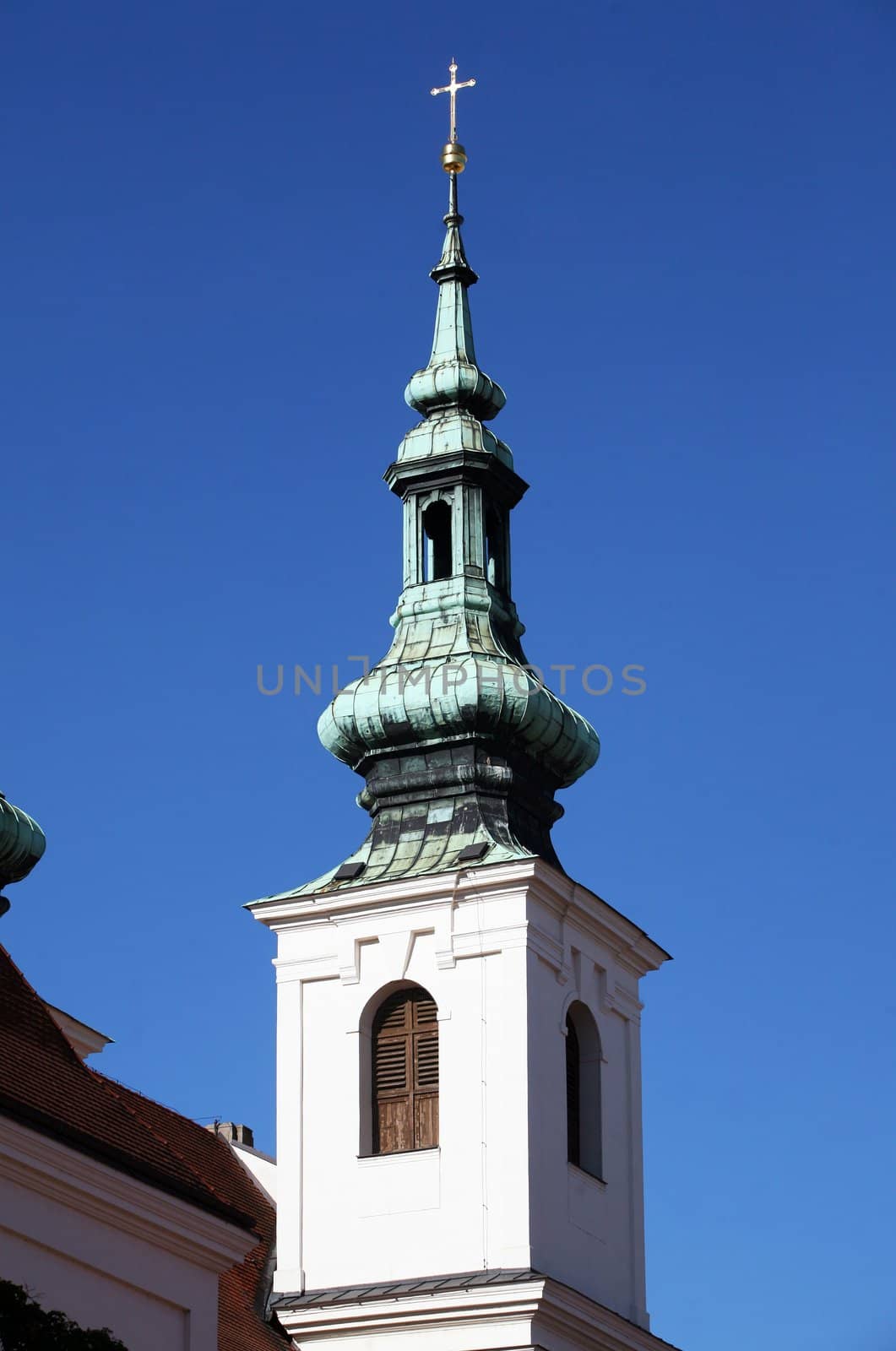 Tower of bohemian church with blue sky behind