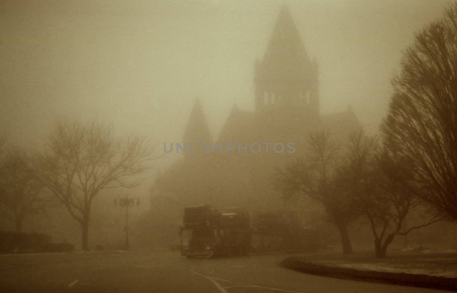 Sepia image of cathedral and truck in heavy fog