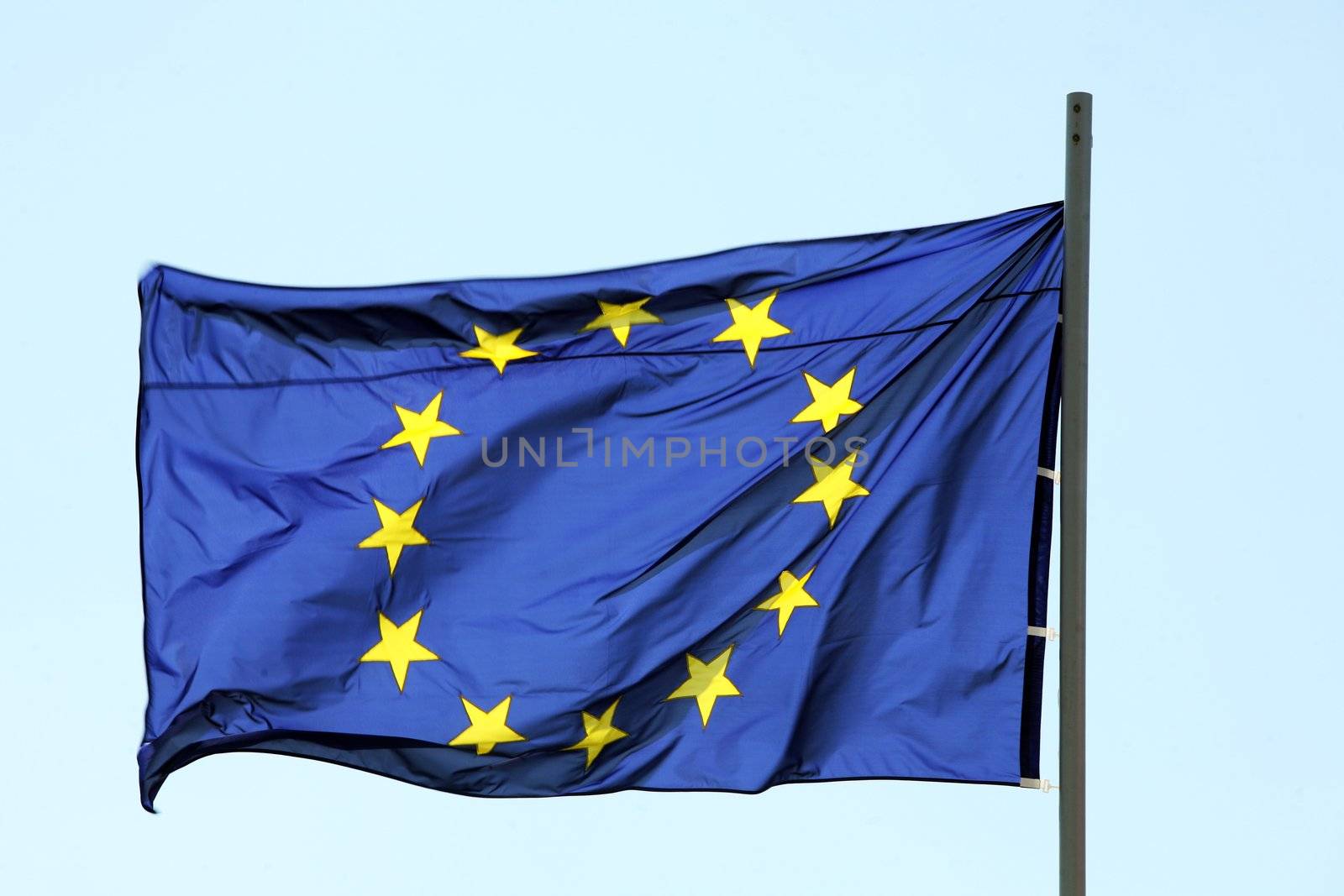 Flag of European Union blowing on blue sky