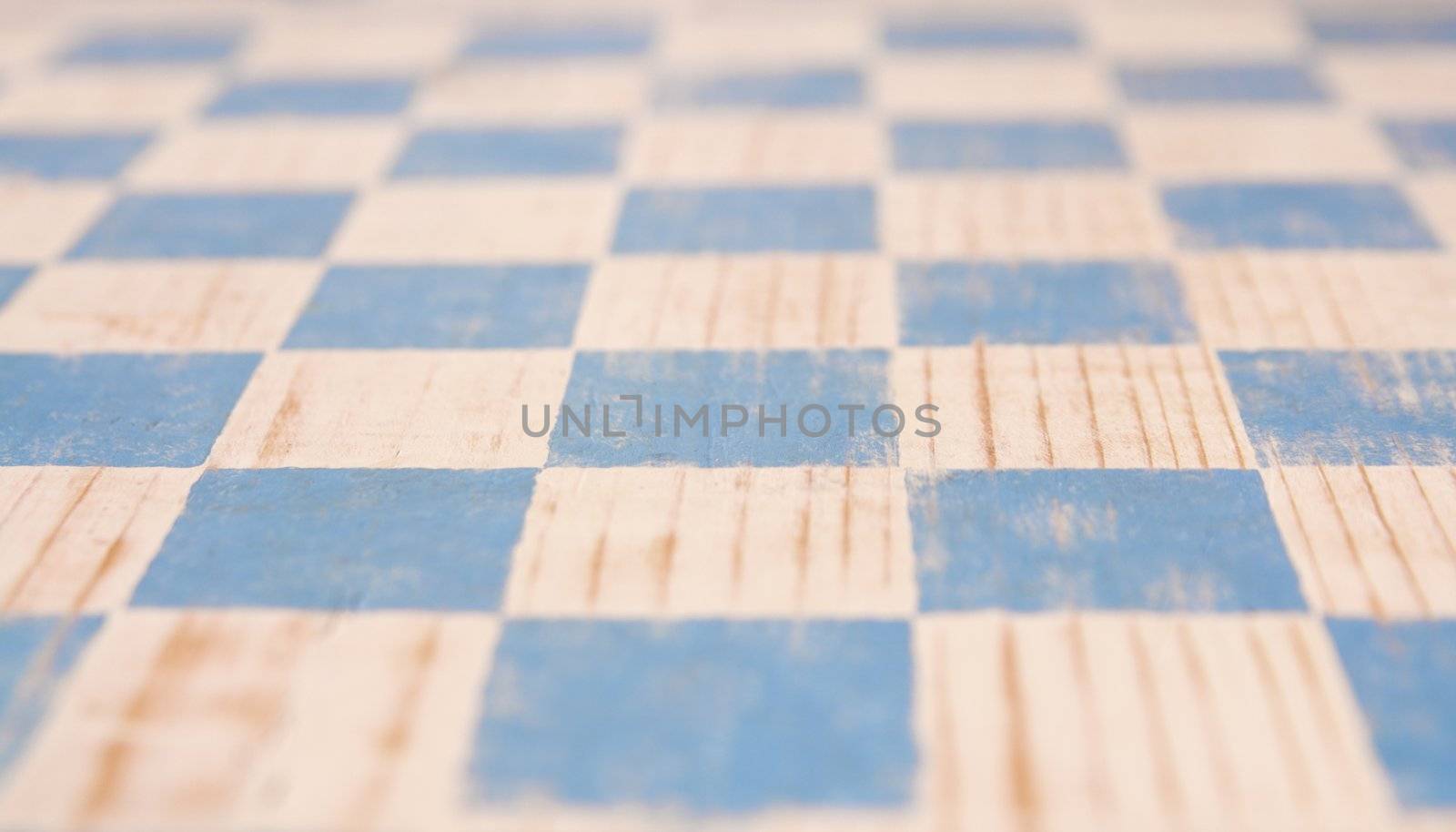 stenciled blue wood checkerboard seen in perspective