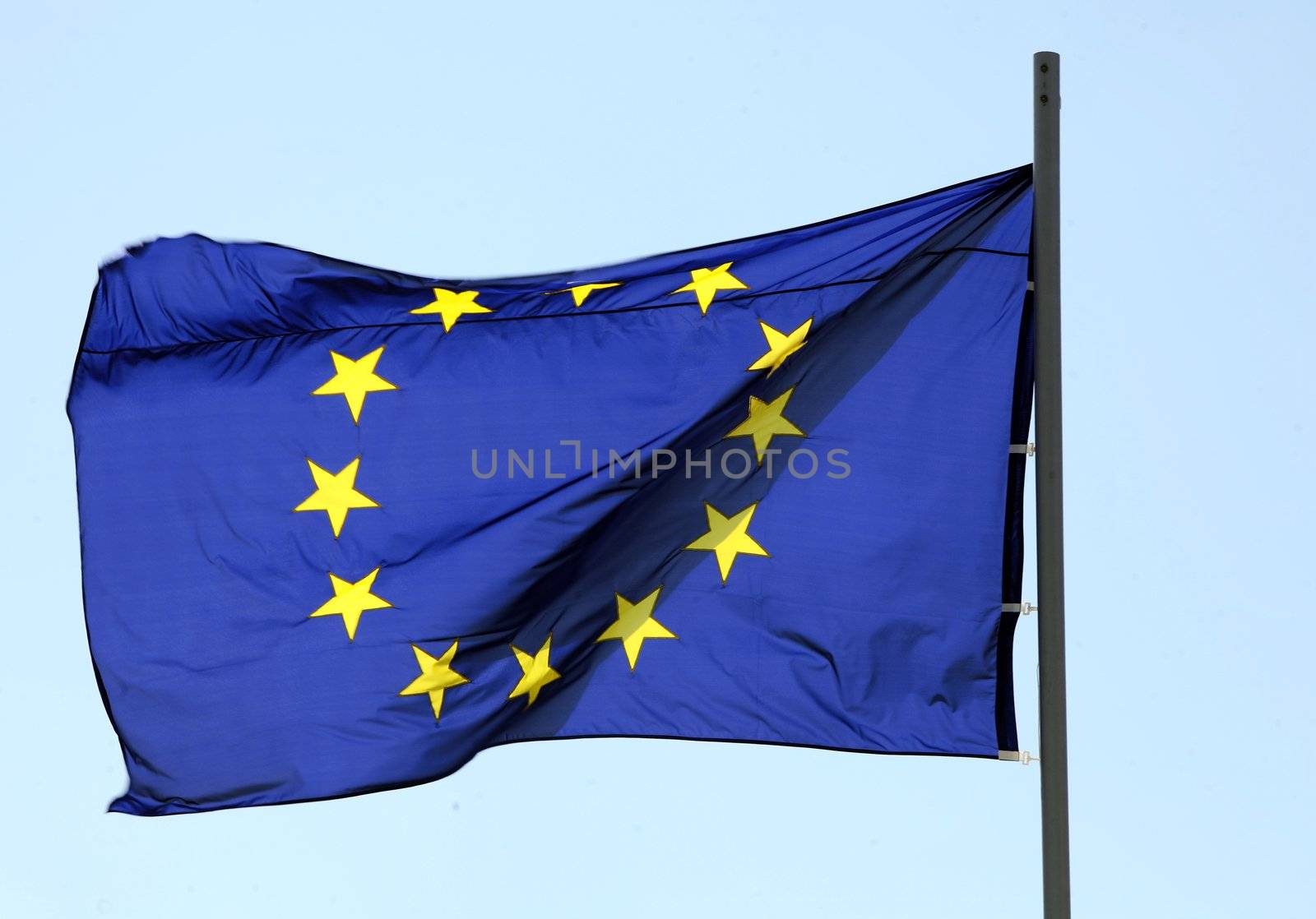 Flag of European Union blowing on blue sky