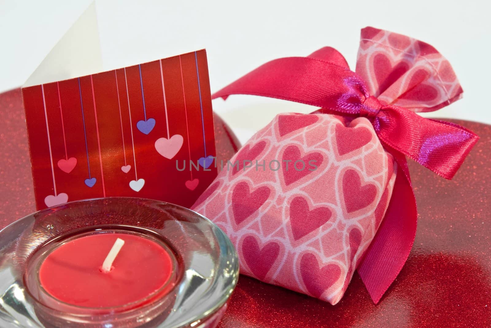 red metallic heart dish with heart sachet with card and candle