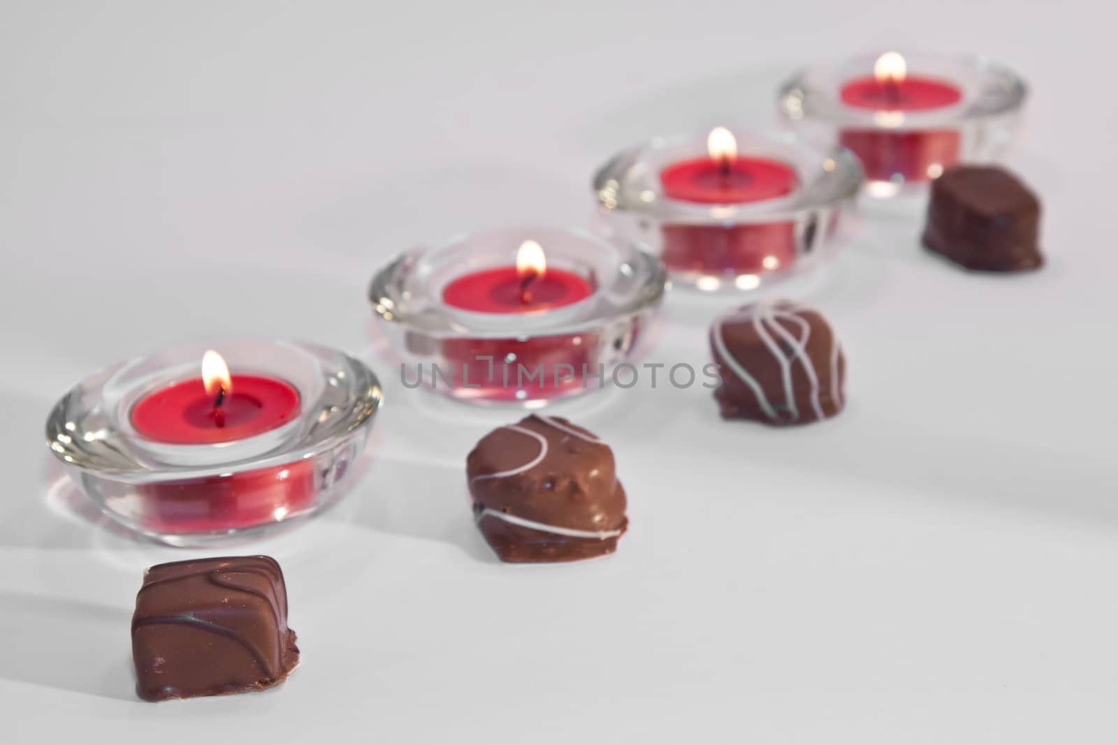 Line of candles and chocolate by timscottrom
