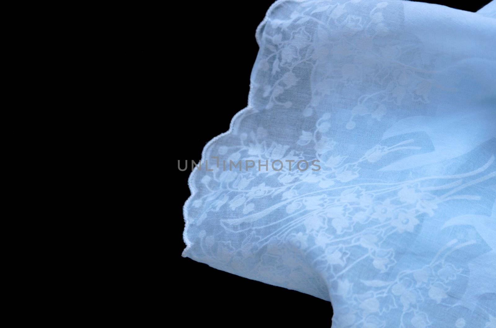 an ice blue handkerchief with delicate flowers on a black background