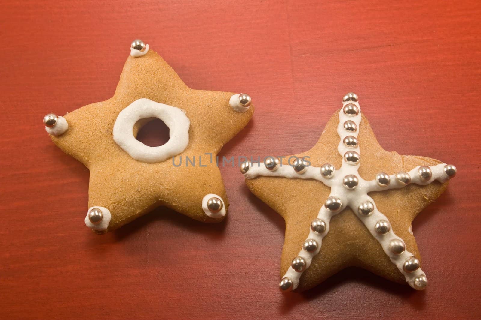 Decorated star shaped cookies on red background