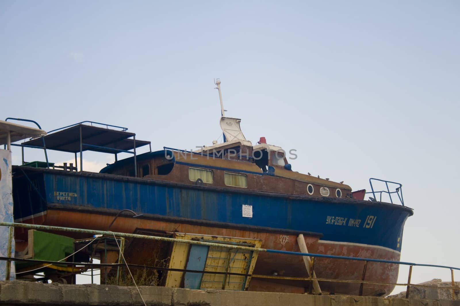 Old rusty fishing vessel sitting on pier