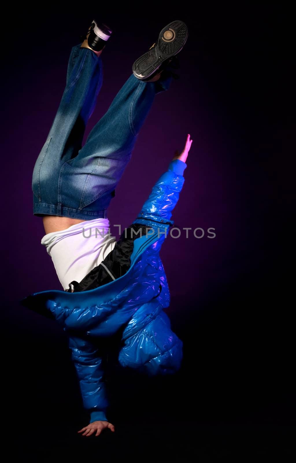 Young hip-hop dancer performing acrobatics. by dgmata