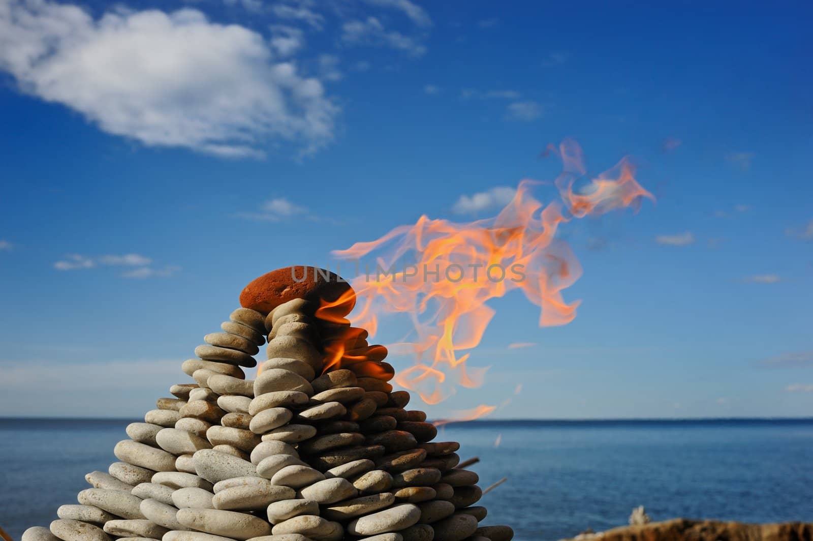 Burn stone pyramid on the bank of northern sea