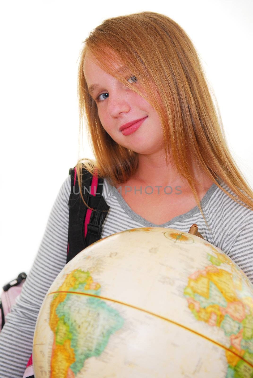 Young smiling girl with a backback and a globe isolated on white background