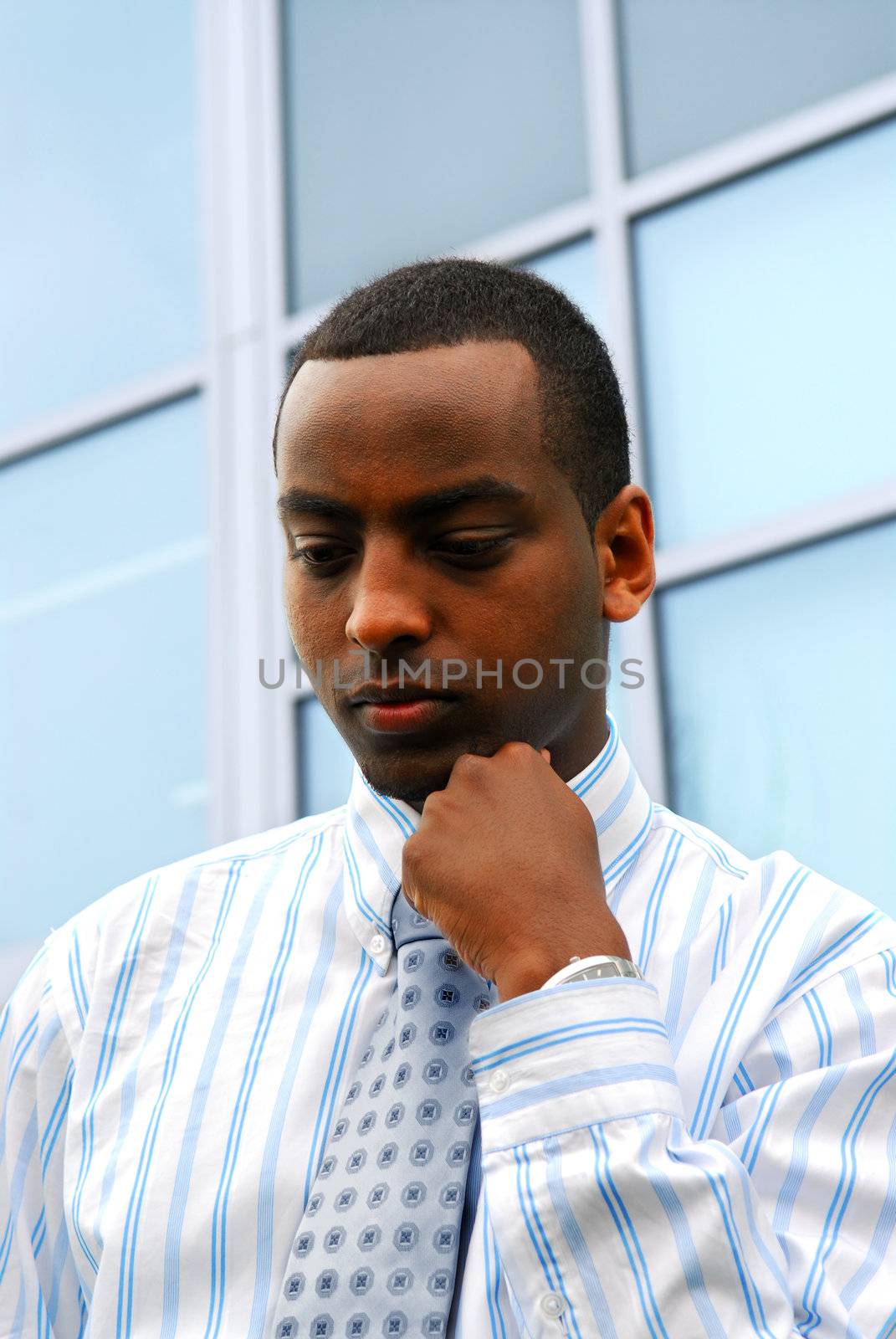 Portrait of a young attractive businessman next to a corporate building