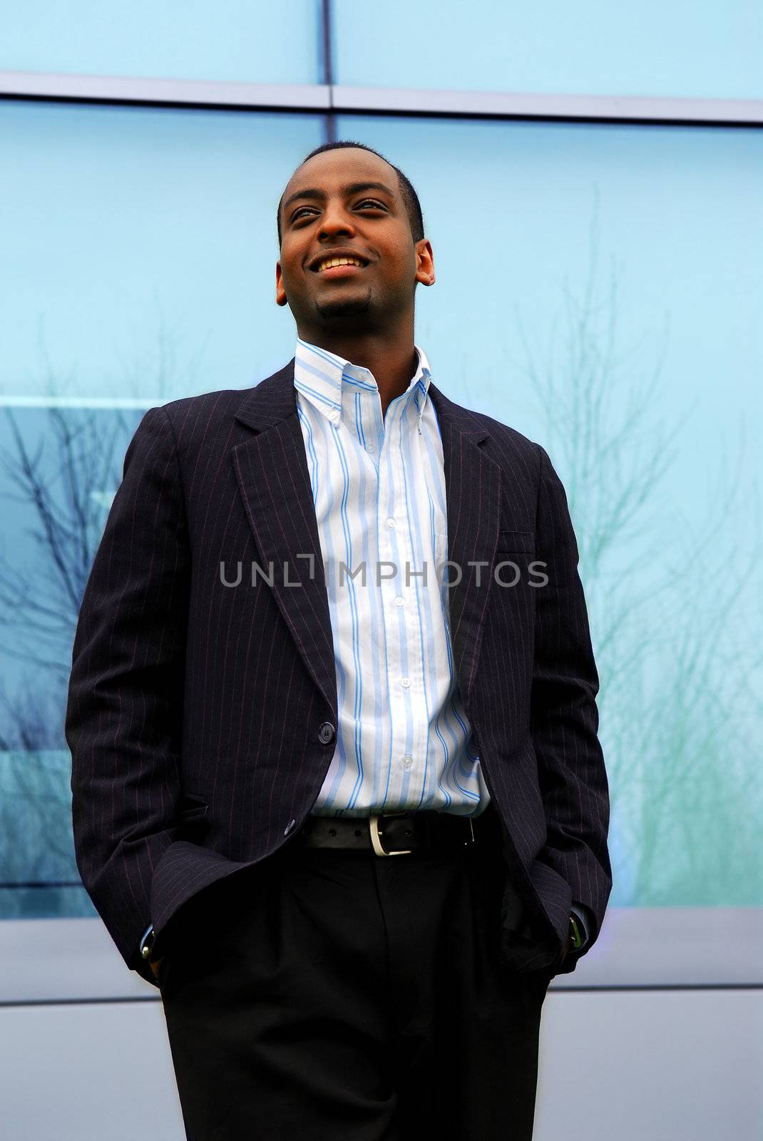 Portrait of a young attractive businessman next to a corporate building