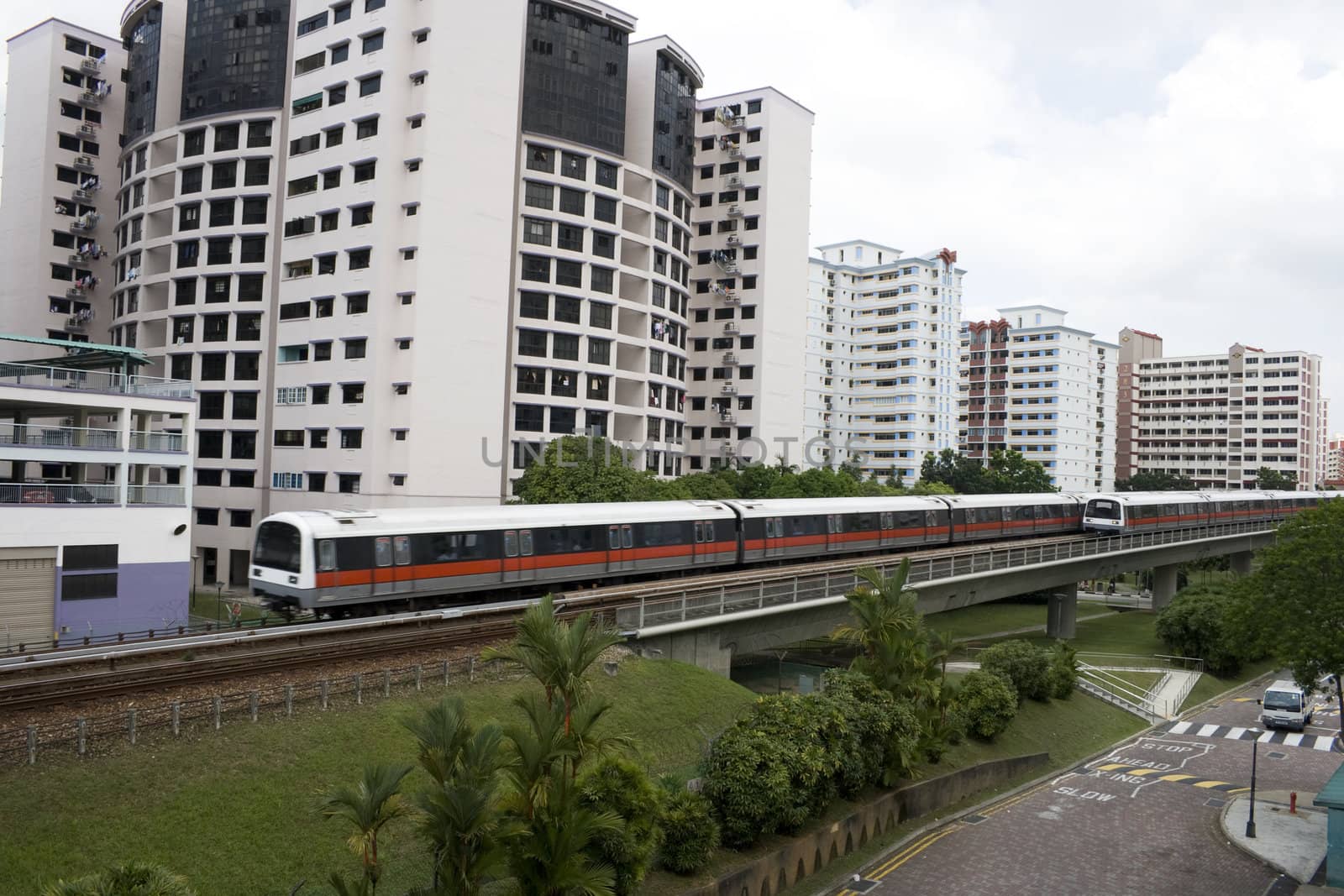 Singapore residential area with train in front.