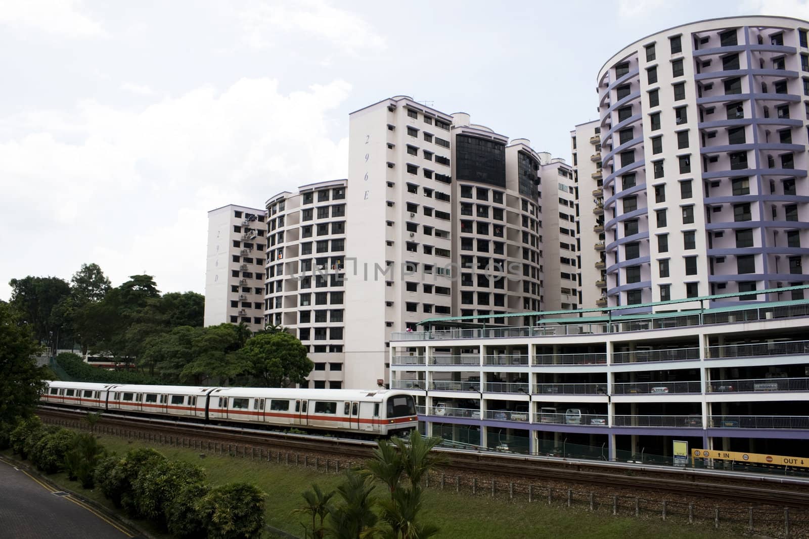 Singapore residential area with train in front.