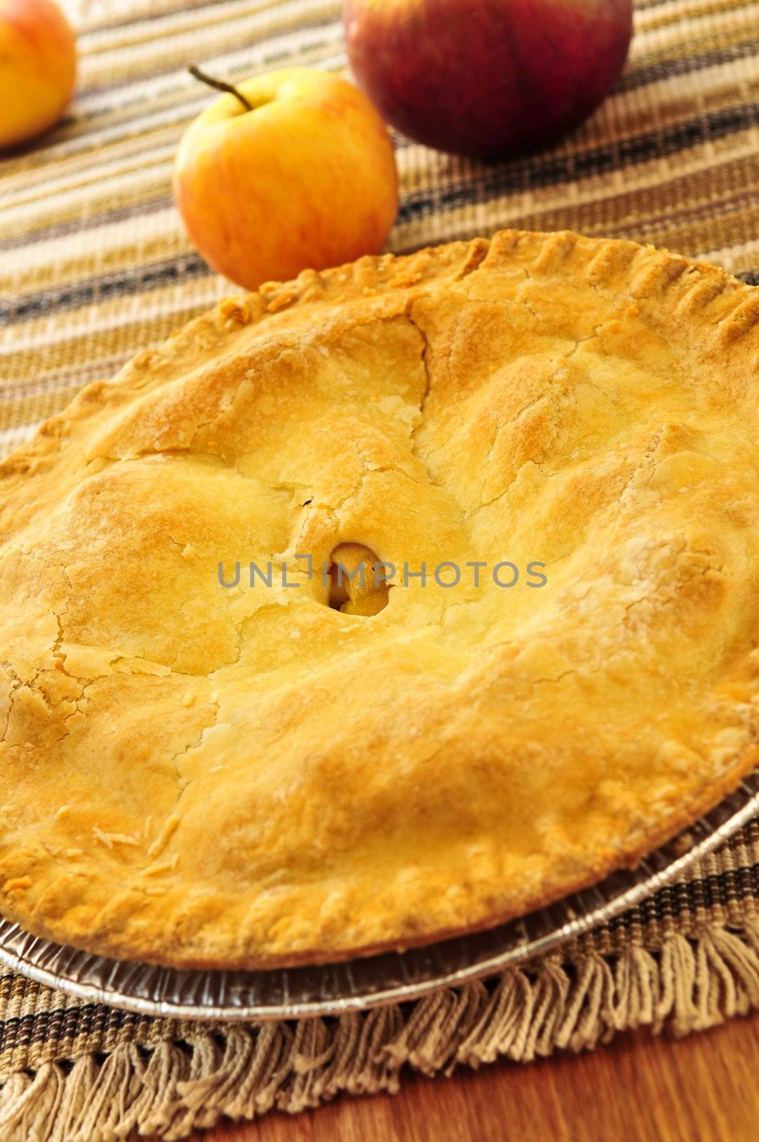 Whole apple pie with apples close up