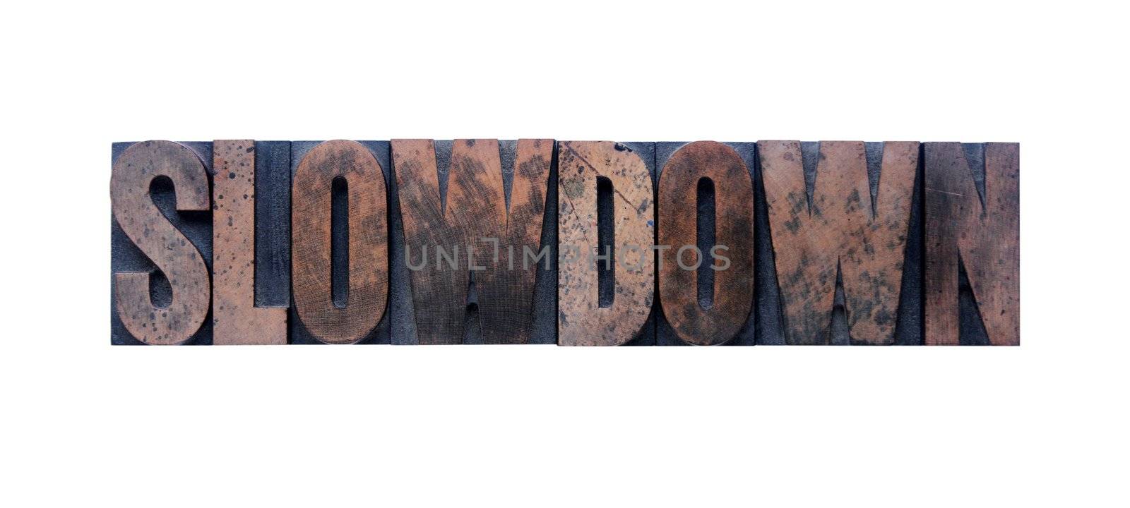 the word 'slowdown' in old ink-stained wood type 