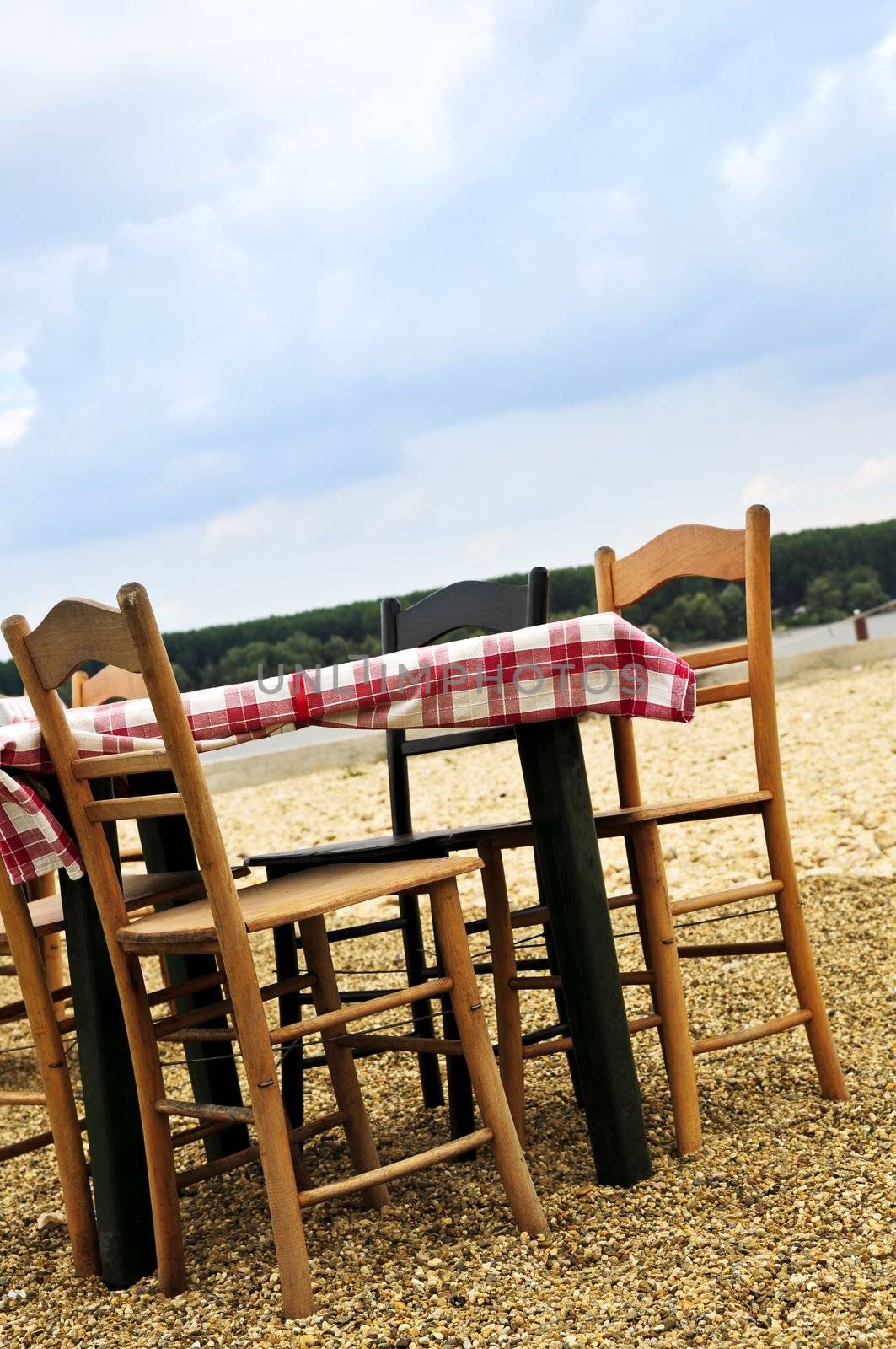 Dining table and chairs set outside on a beach