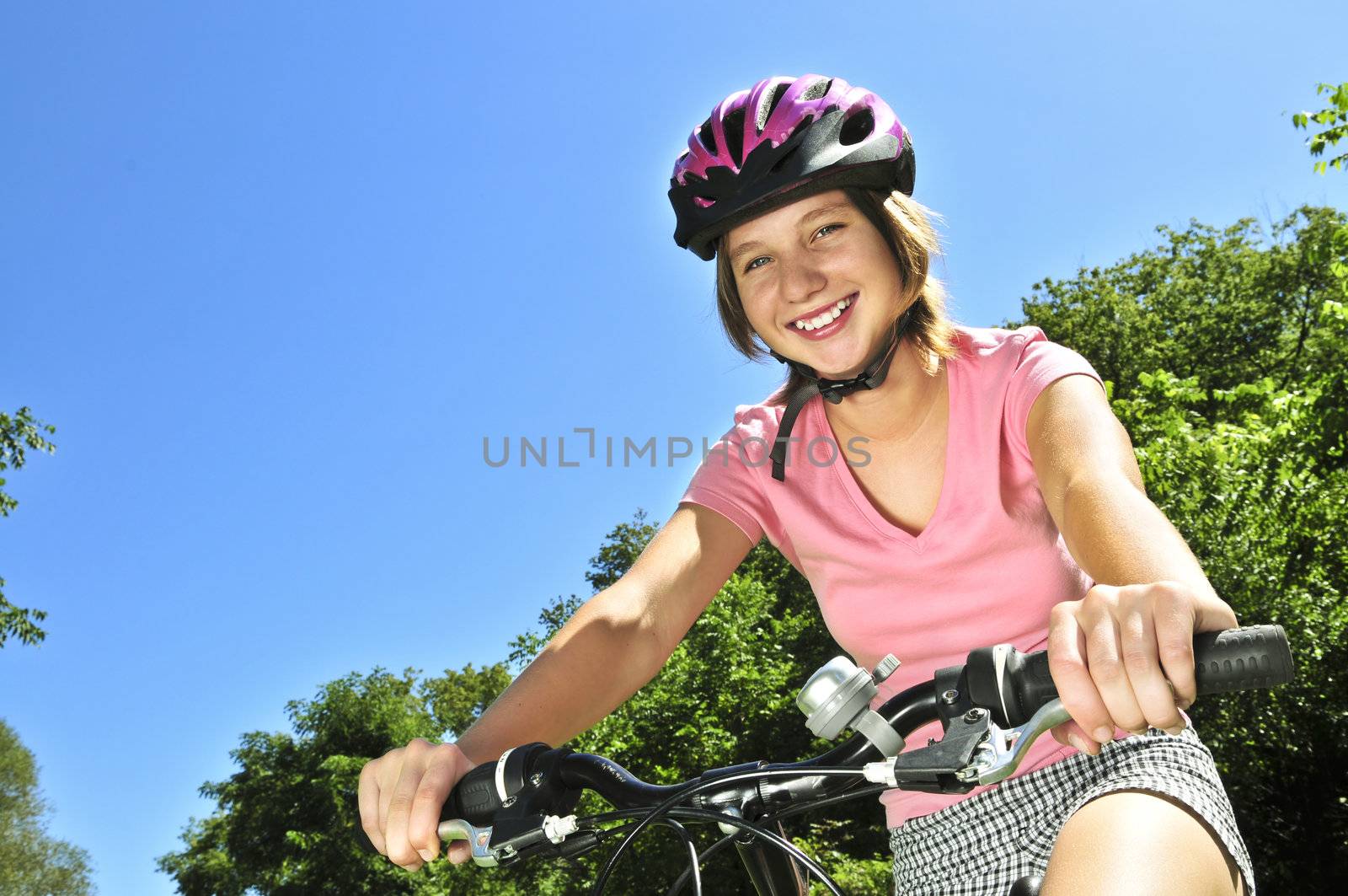 Teenage girl on a bicycle by elenathewise