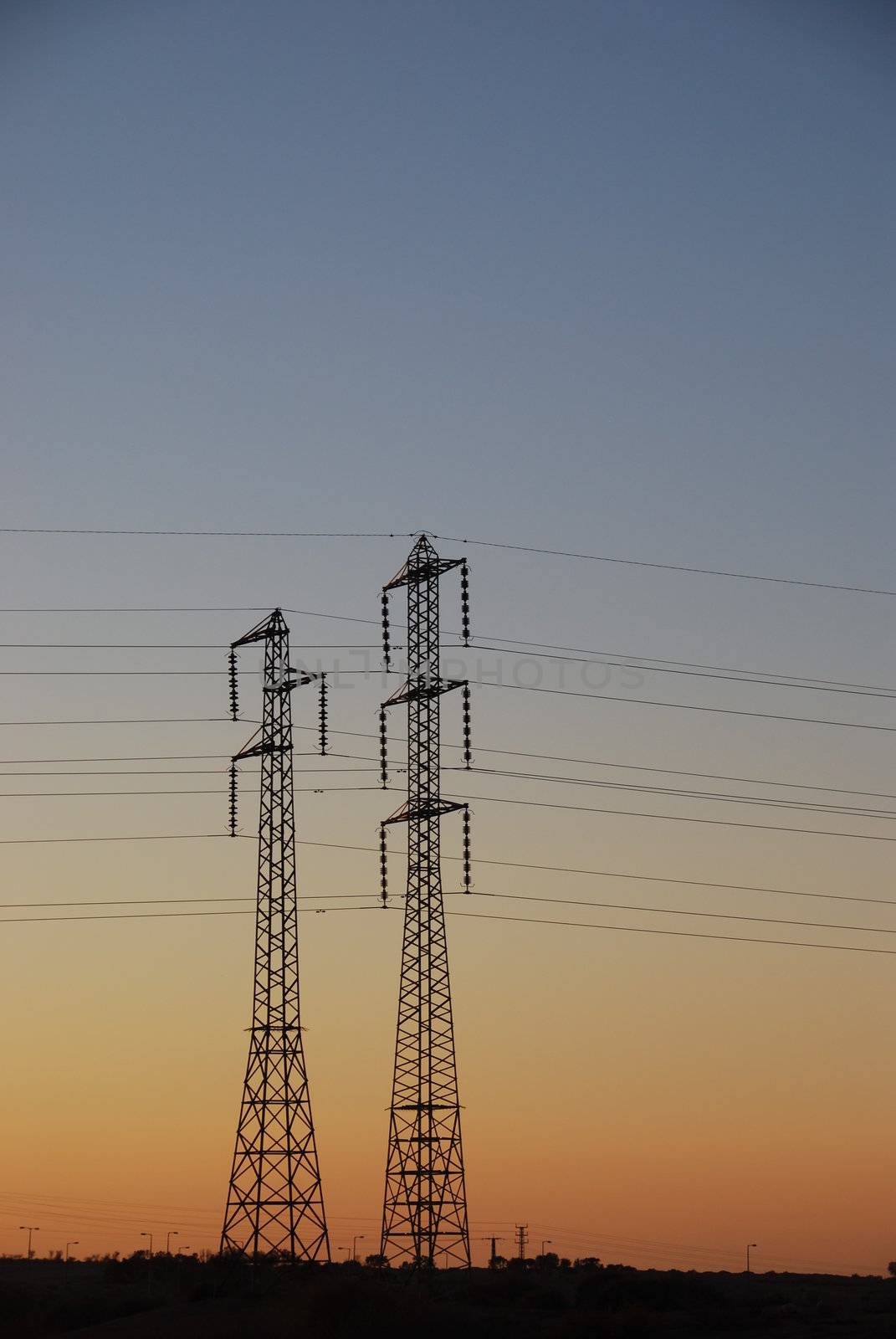 Electrical towers and wires on sunset background 