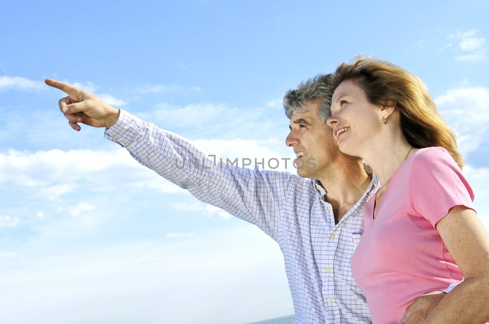 Mature romantic couple of baby boomers looking at the sky