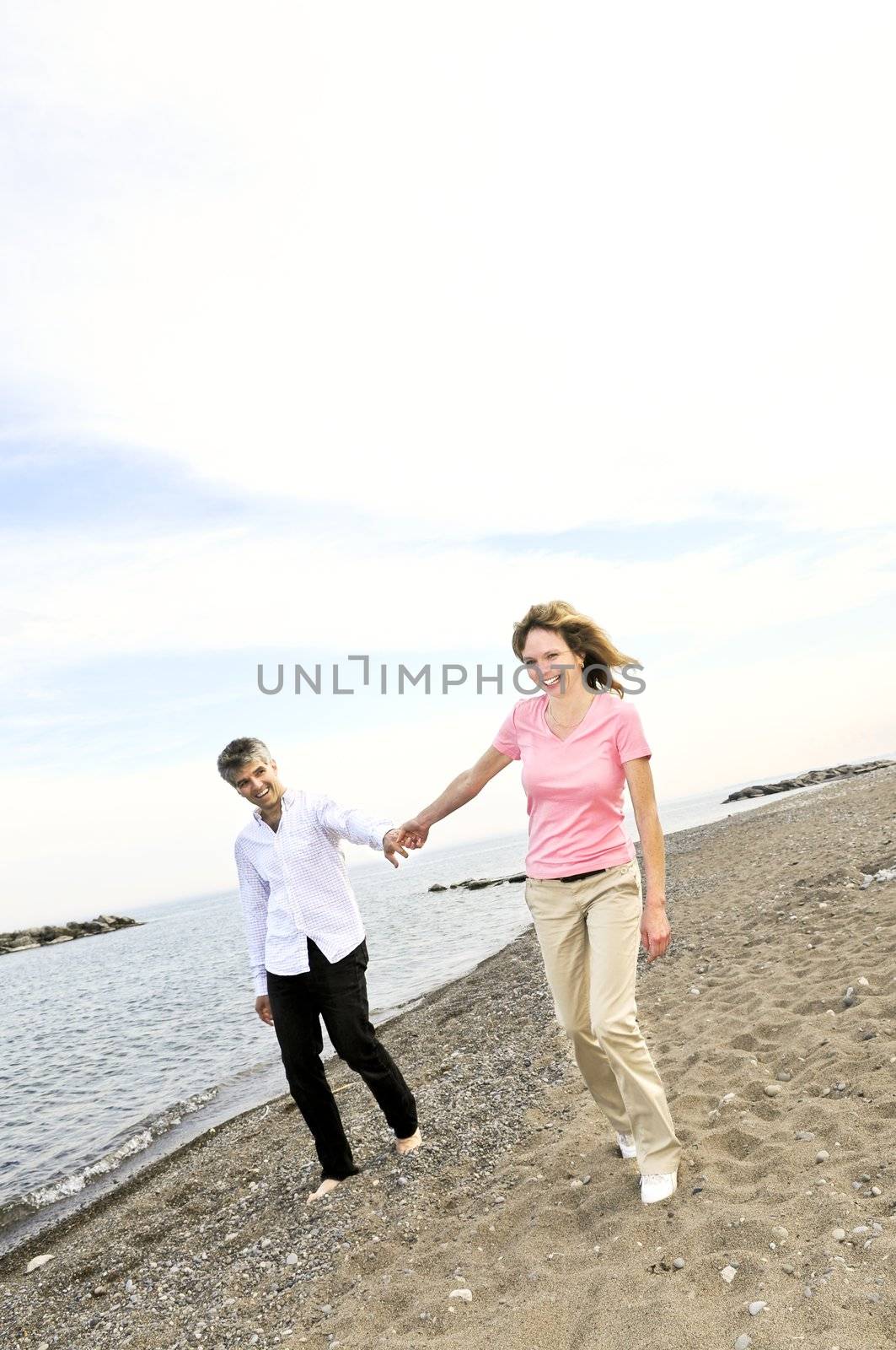 Mature romantic couple walking on a beach