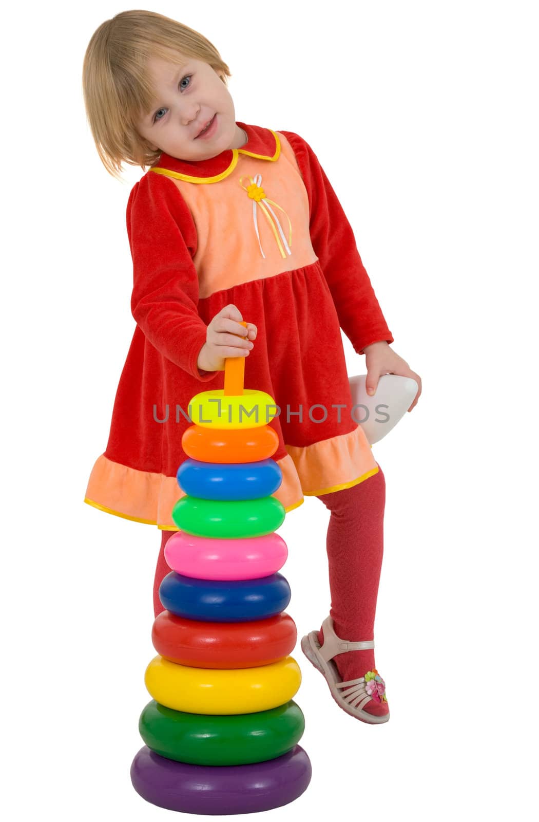 Little girl holding plastic toy pyramid on white