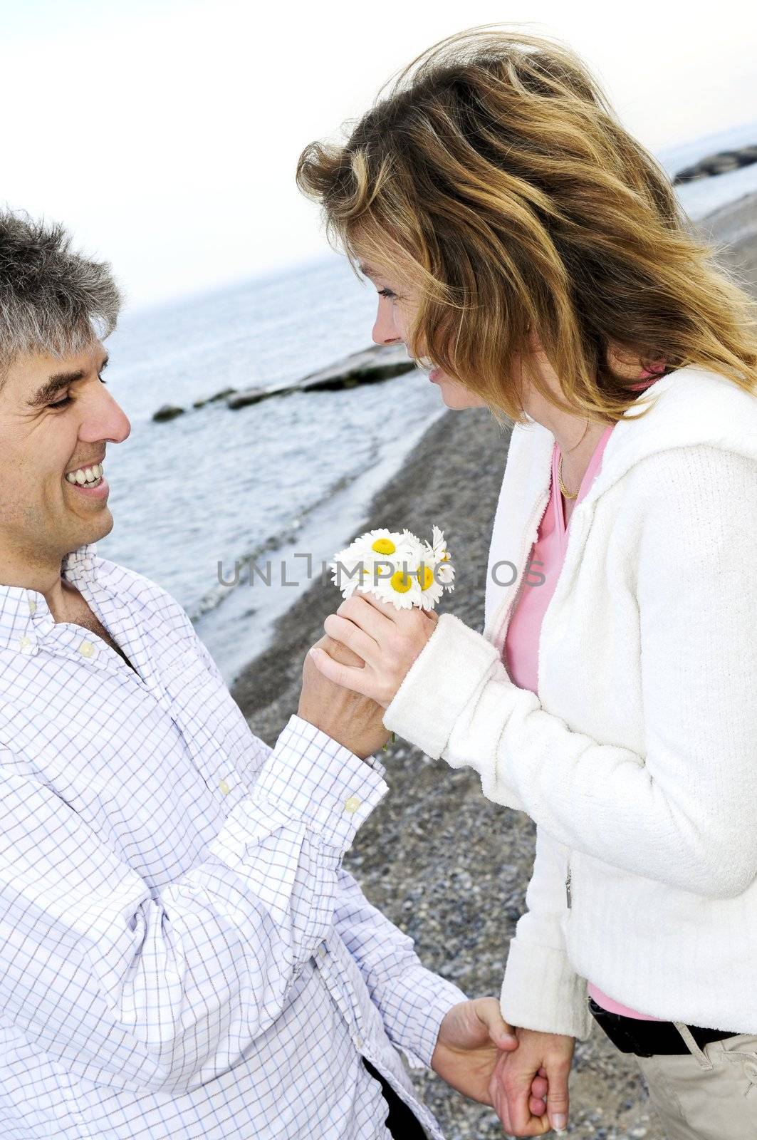 Mature romantic couple with flowers by elenathewise